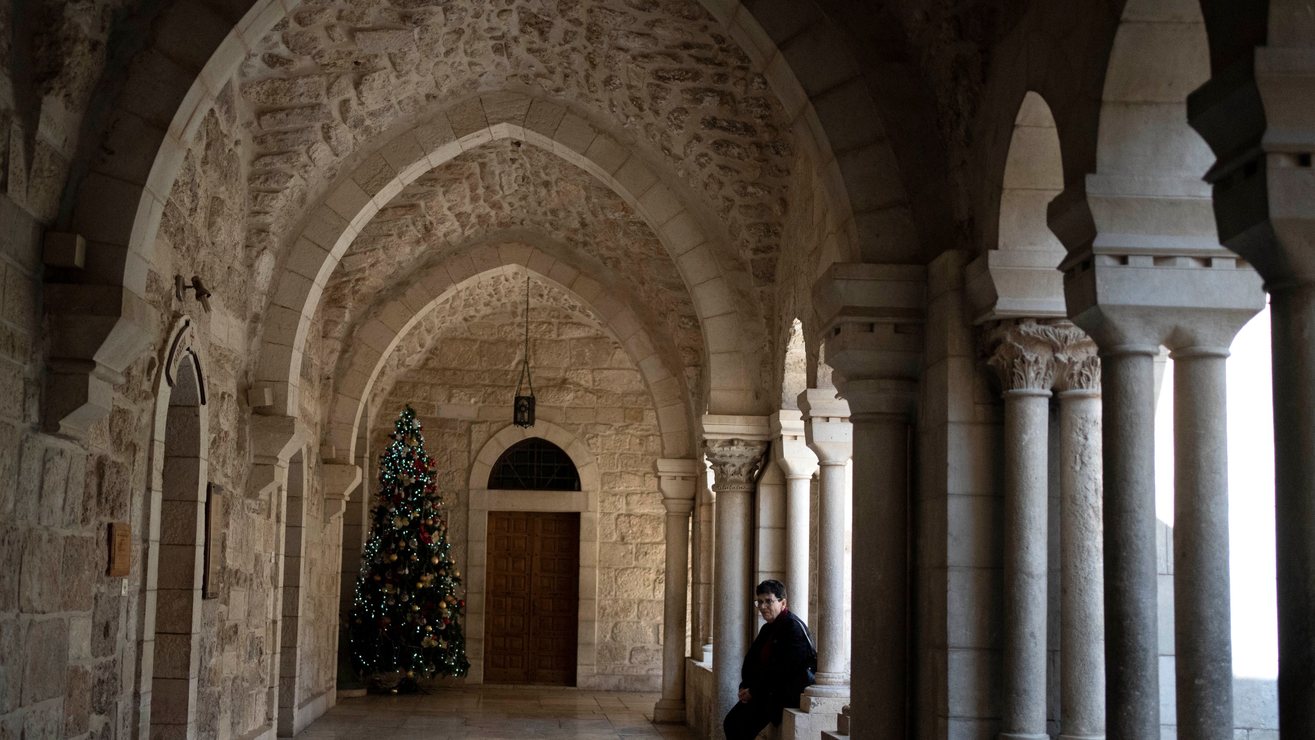 A lone Christmas tree is seen in the Church of the Nativity complex, where Christians believe Jesus Christ was born, ahead of Orthodox Christmas Eve mass in the West Bank city of Bethlehem, Monday, Jan. 6, 2025. (AP Photo/Maya Alleruzzo)