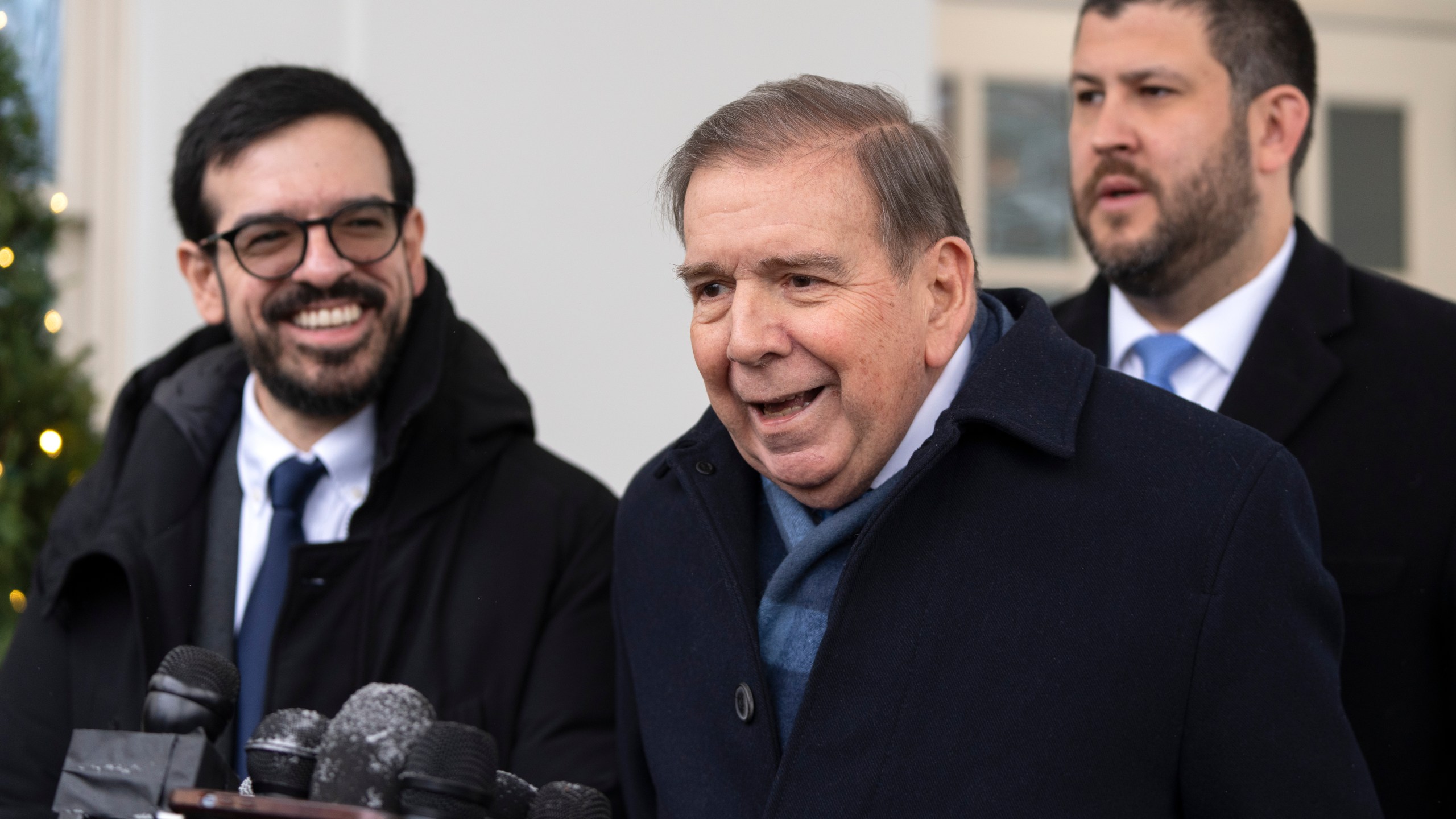 Venezuela's opposition leader Edmundo Gonzalez, center, speaks with reporters at the White House, Monday, Jan. 6, 2025, in Washington. (AP Photo/Mark Schiefelbein)