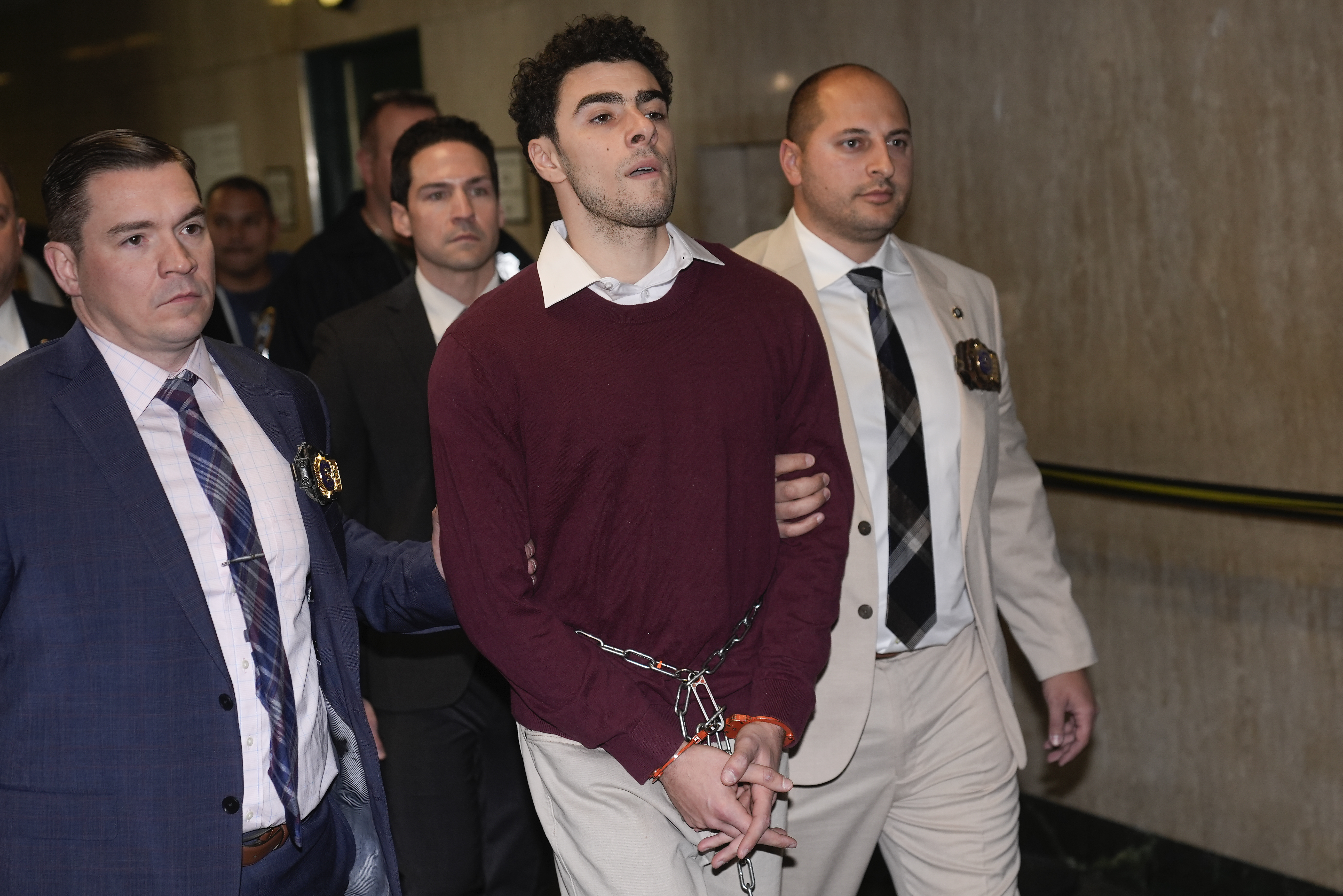 Luigi Mangione is escorted into Manhattan Criminal court for his arraignment on state murder and terror charges in the killing of UnitedHealthcare CEO Brian Thompson, Monday, Dec. 23, 2024, in New York. (AP Photo/Seth Wenig)