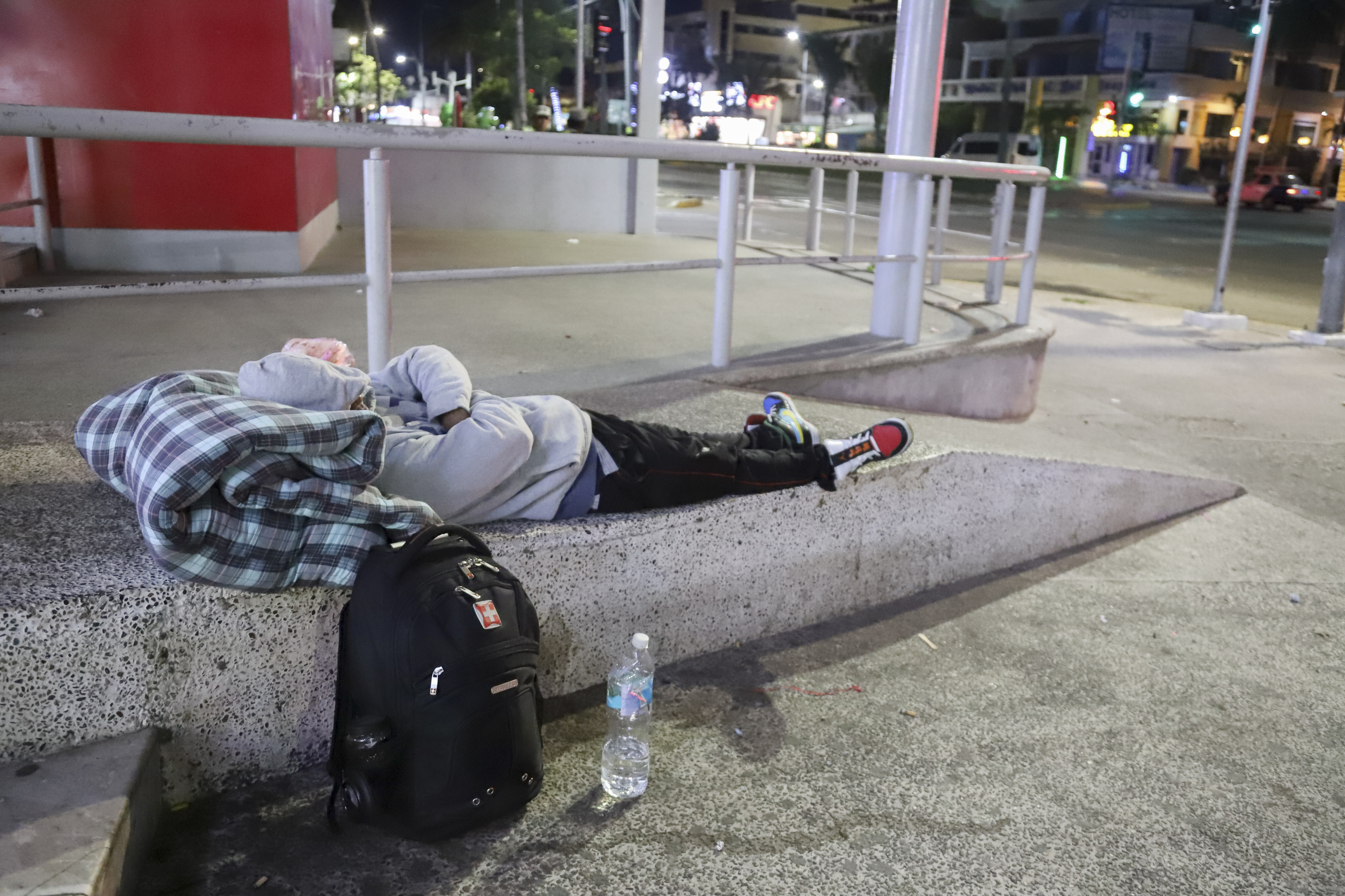 A migrant sleeps on the side of a street in Acapulco, Mexico, Monday, Jan. 6, 2025. (AP Photo/Bernardino Hernandez)