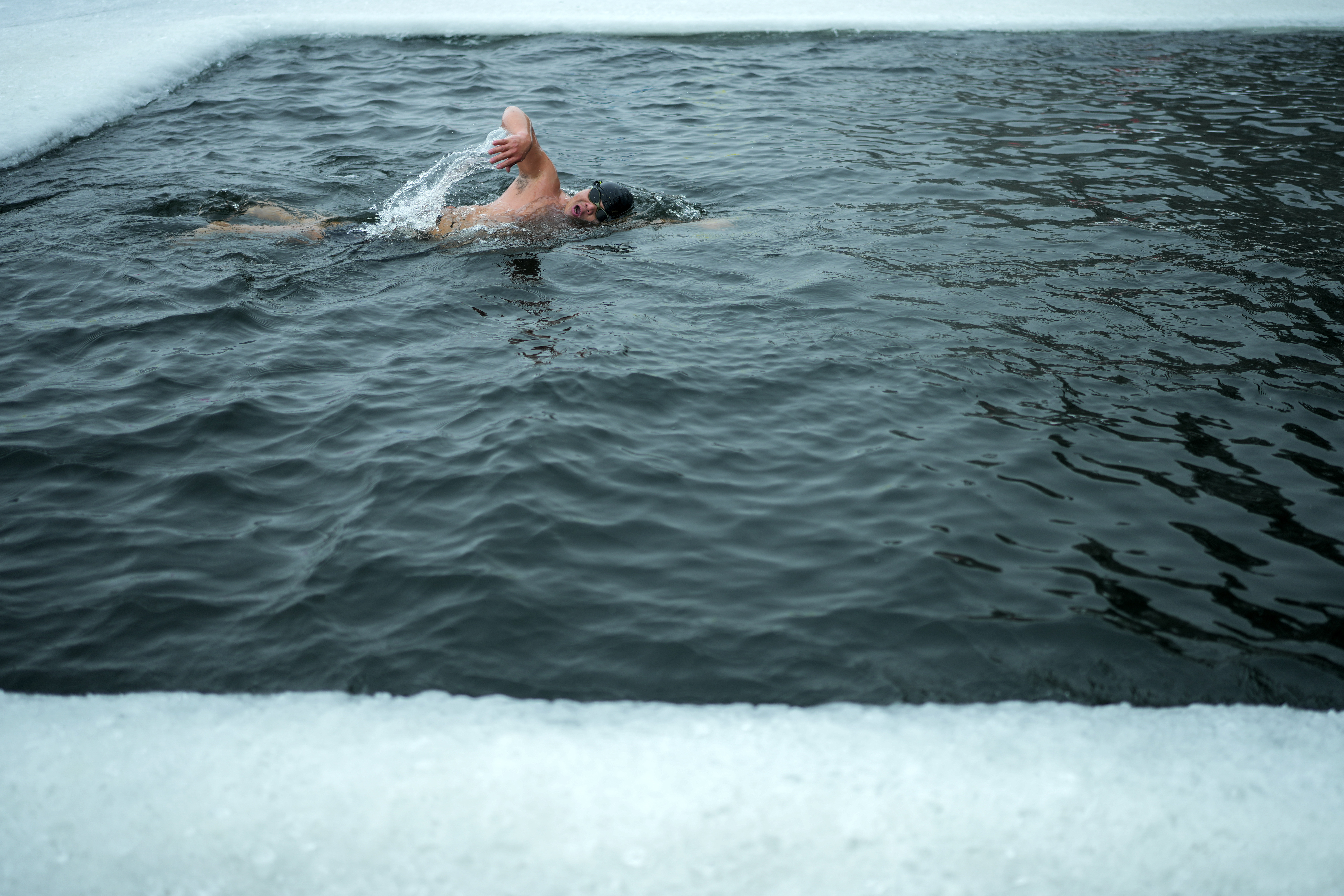 A resident swims in a pool carved from ice on the frozen Songhua river in Harbin in northeastern China's Heilongjiang province, Tuesday, Jan. 7, 2025. (AP Photo/Andy Wong)