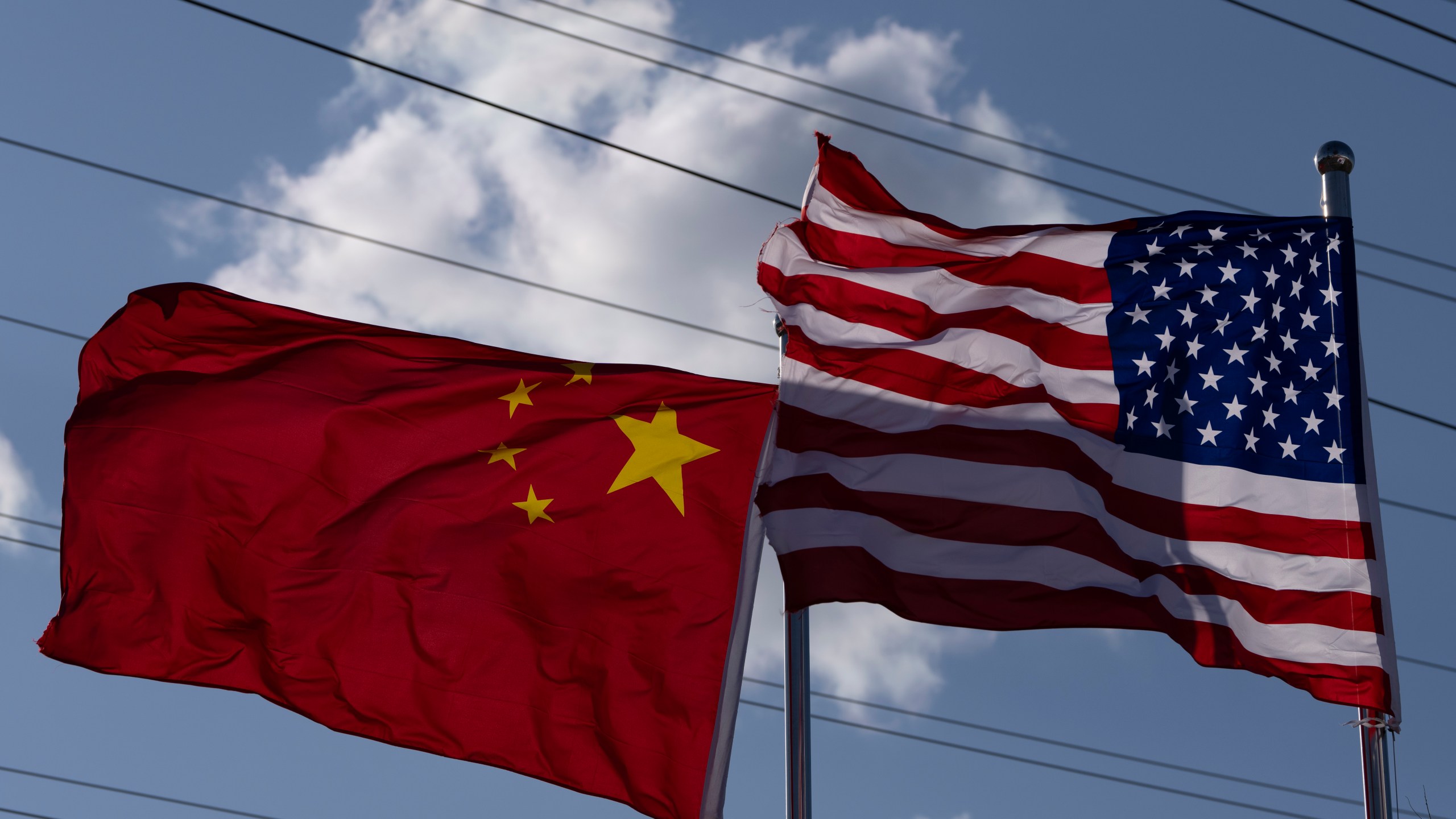 The Chinese and United States flags are flown outside the China International Supply Chain Expo in Beijing, Nov. 27, 2024. (AP Photo/Ng Han Guan)