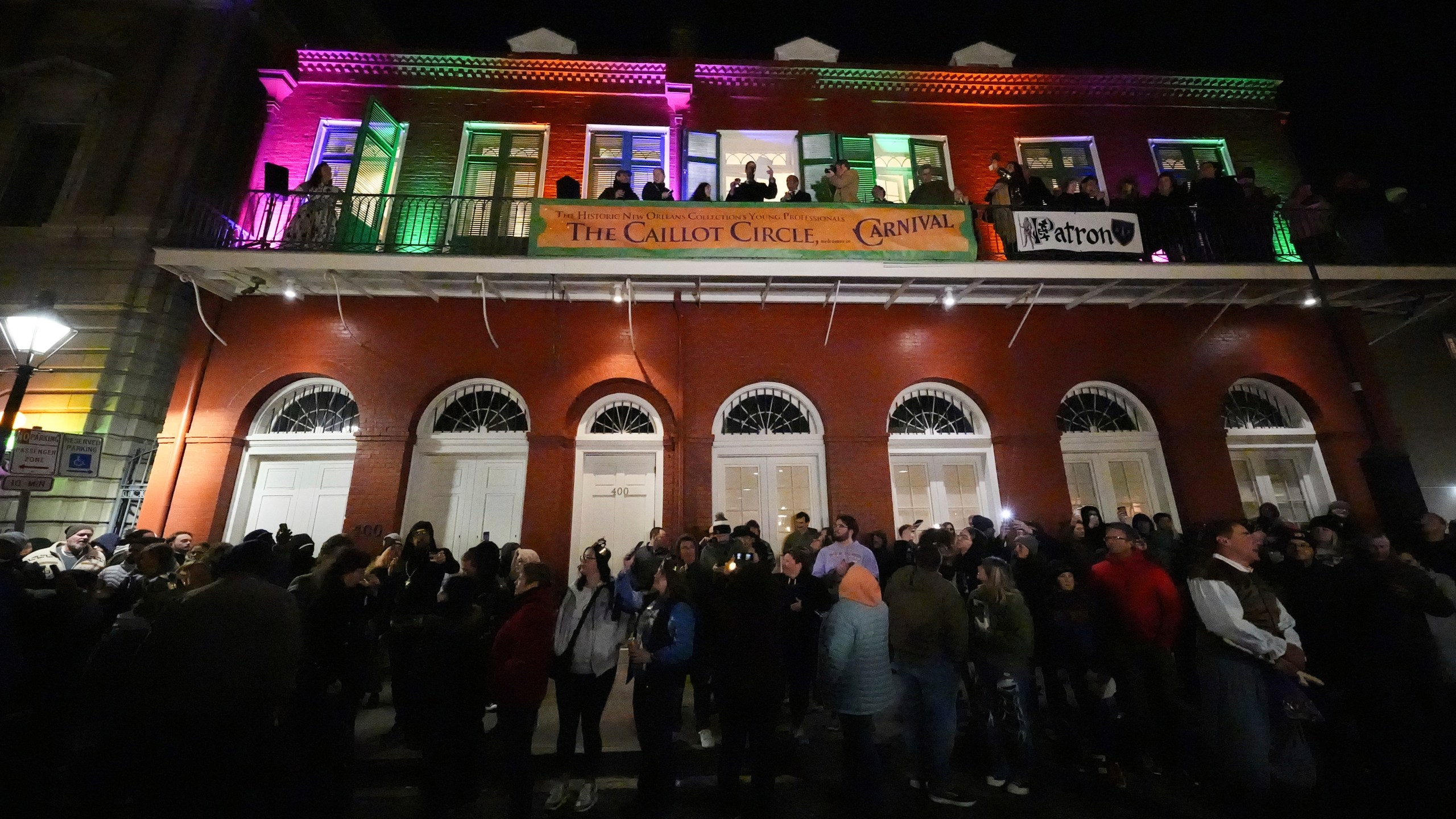 Parade attendees toast to victims of the deadly New Years truck attack, during the annual Krewe de Jeanne d'Arc parade, kicking off the Mardi Gras season, in New Orleans, Monday, Jan. 6, 2025. (AP Photo/Gerald Herbert)