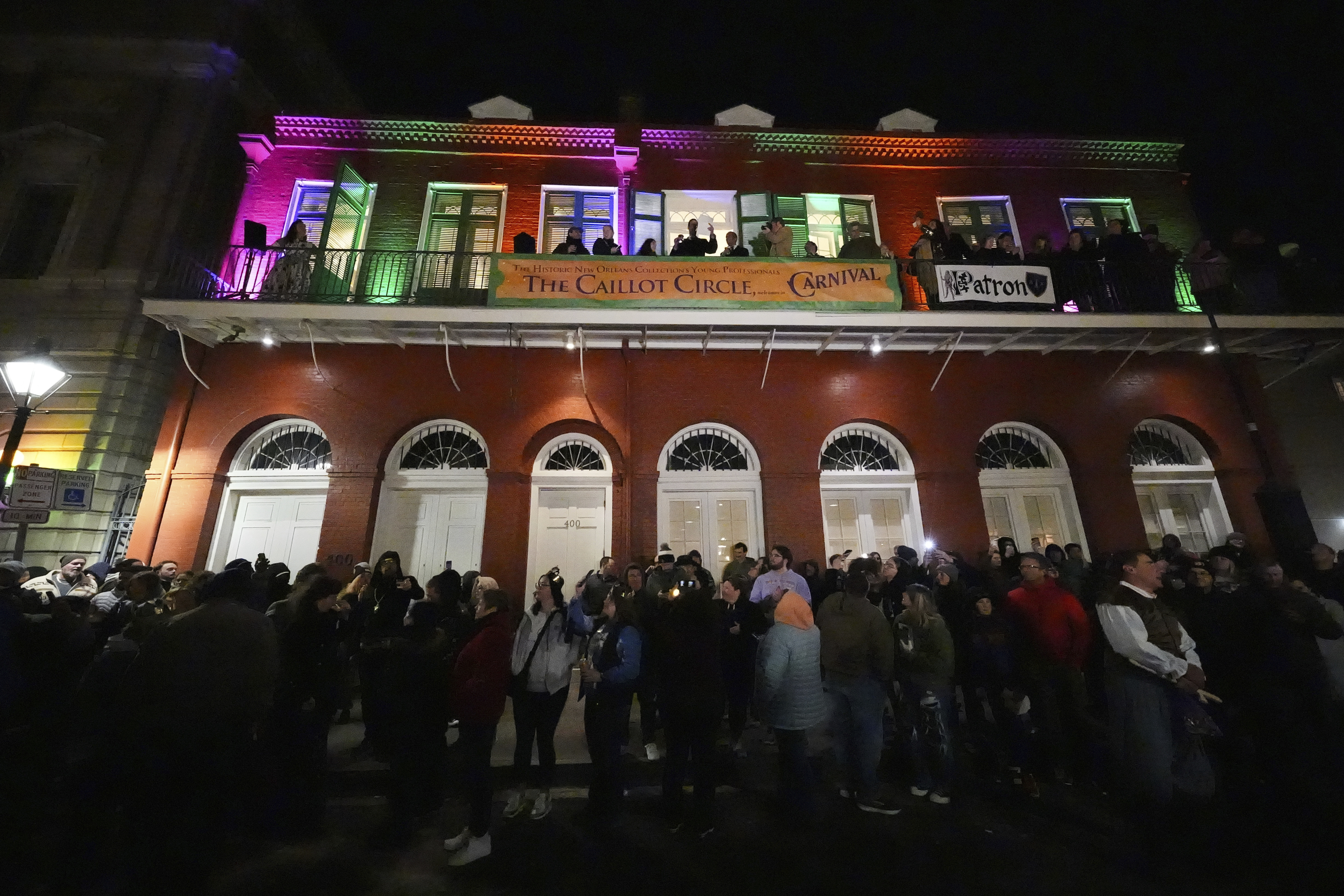 Parade attendees toast to victims of the deadly New Years truck attack, during the annual Krewe de Jeanne d'Arc parade, kicking off the Mardi Gras season, in New Orleans, Monday, Jan. 6, 2025. (AP Photo/Gerald Herbert)