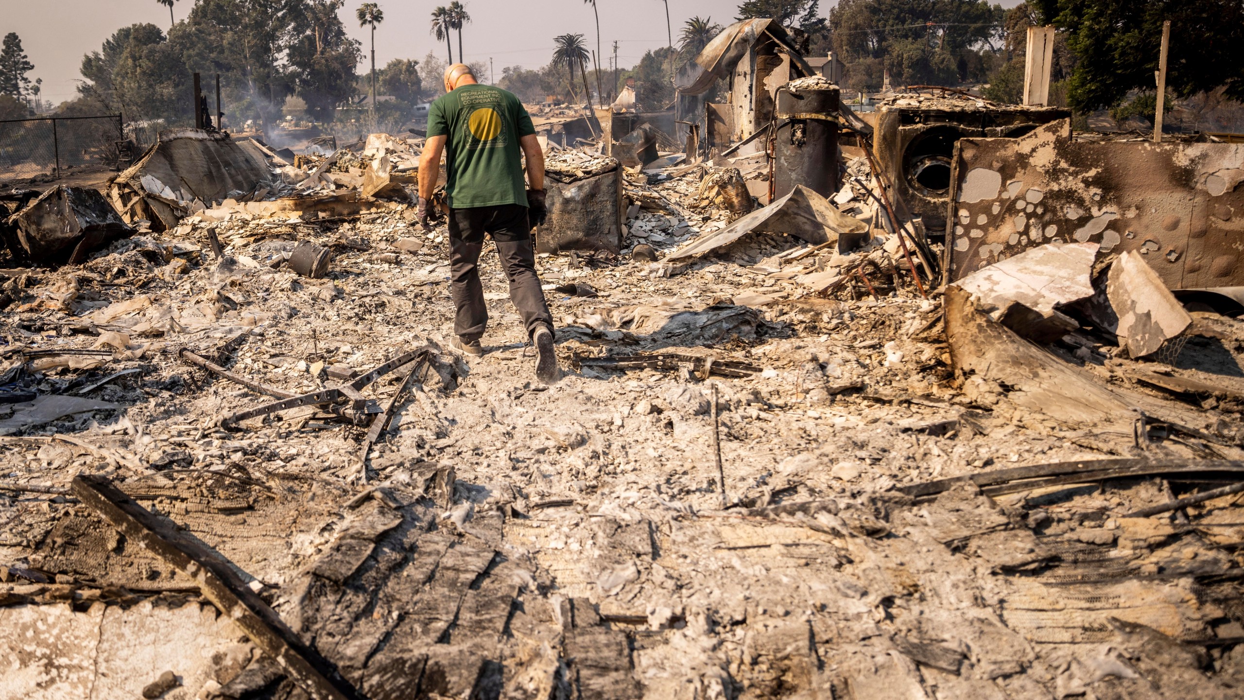 FILE - Marvin Meador walks on the remains of his fire-ravaged property after the Mountain Fire swept through, Nov. 7, 2024, in Camarillo, Calif. (AP Photo/Ethan Swope, File)