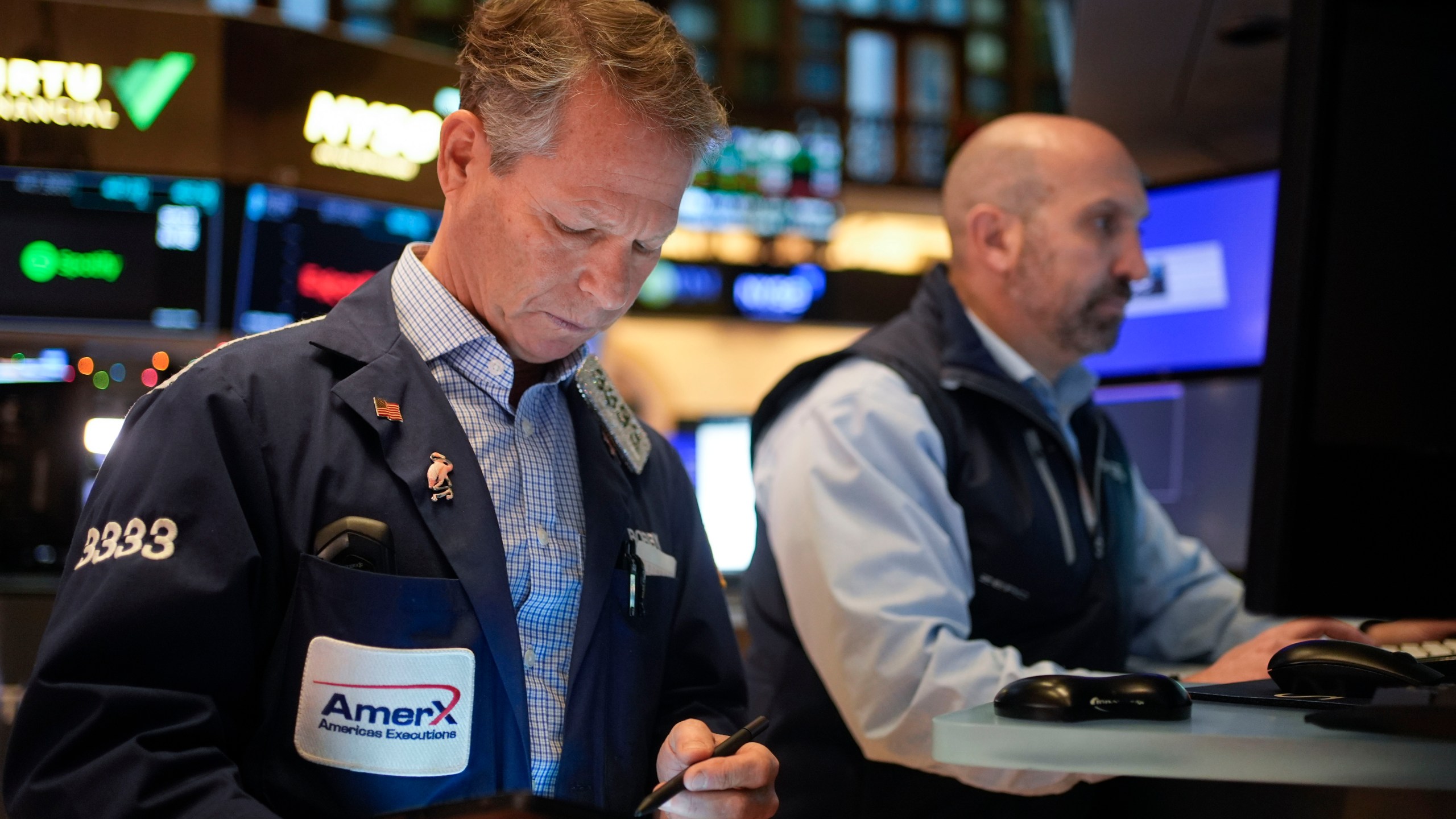 Traders work on the floor at the New York Stock Exchange in New York's Financial District Thursday, Jan. 2, 2025. (AP Photo/Seth Wenig)