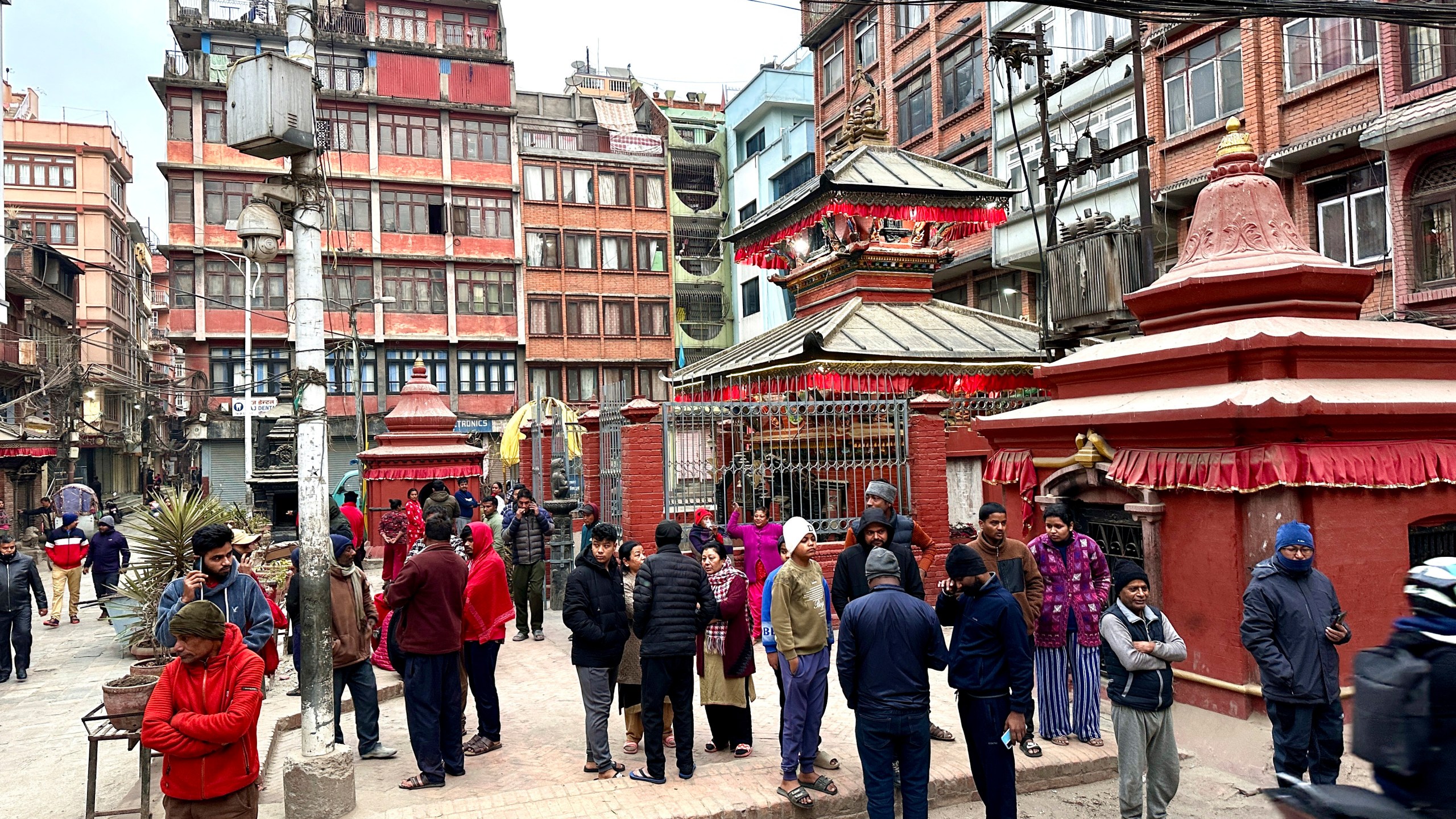 Nepalese people stand after rushing out of their homes after experiencing an earthquake in Kathmandu, Nepal, Tuesday, Jan.7, 2025. (AP Photo/Sunil Sharma)