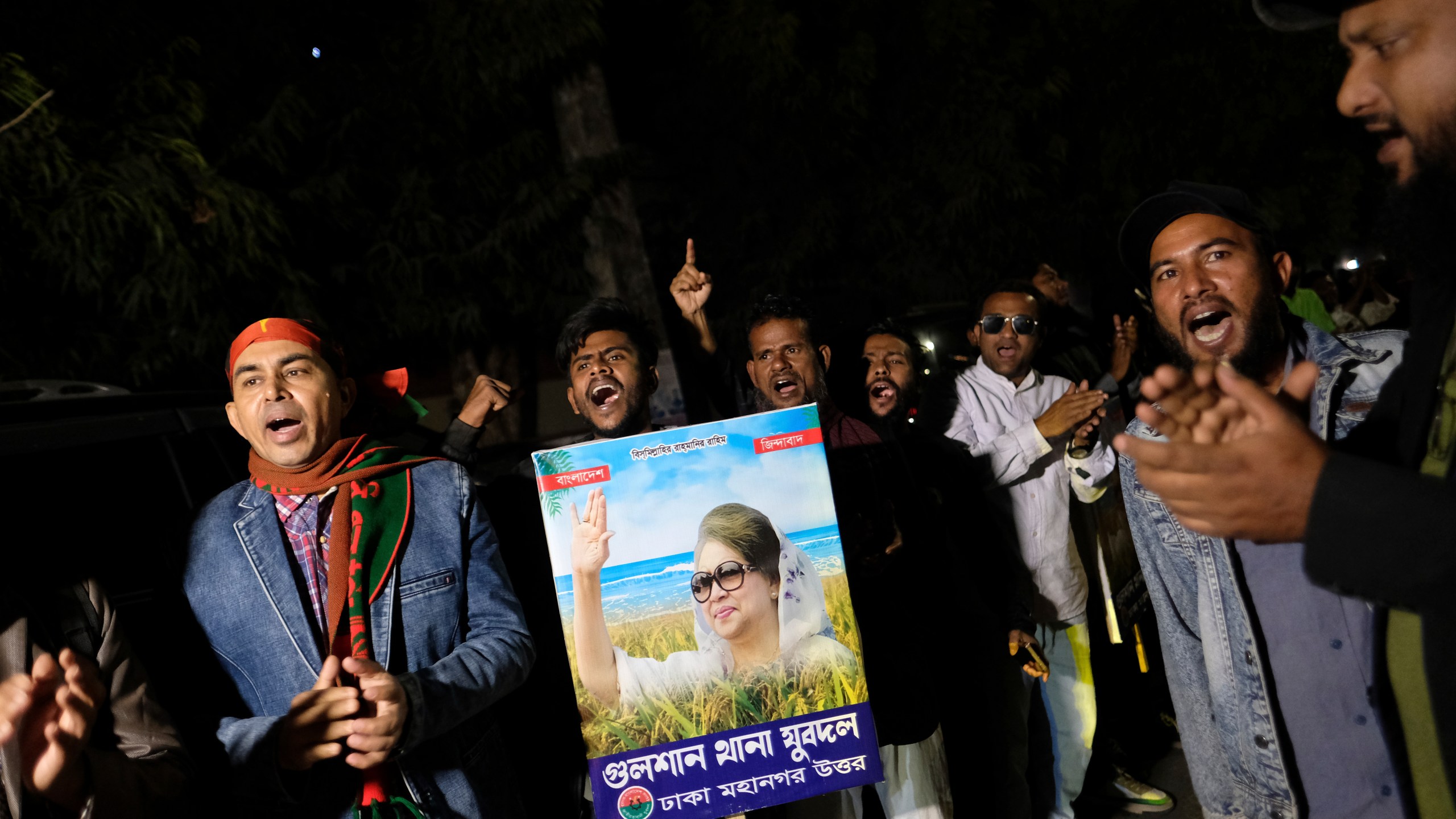 Supporters of Bangladesh's ailing former Prime Minister Khaleda Zia shout slogans before Zia left Dhaka, Bangladesh, to travel to London for medical treatment, Tuesday, Jan. 7, 2025. (AP Photo/Mahmud Hossain Opu)