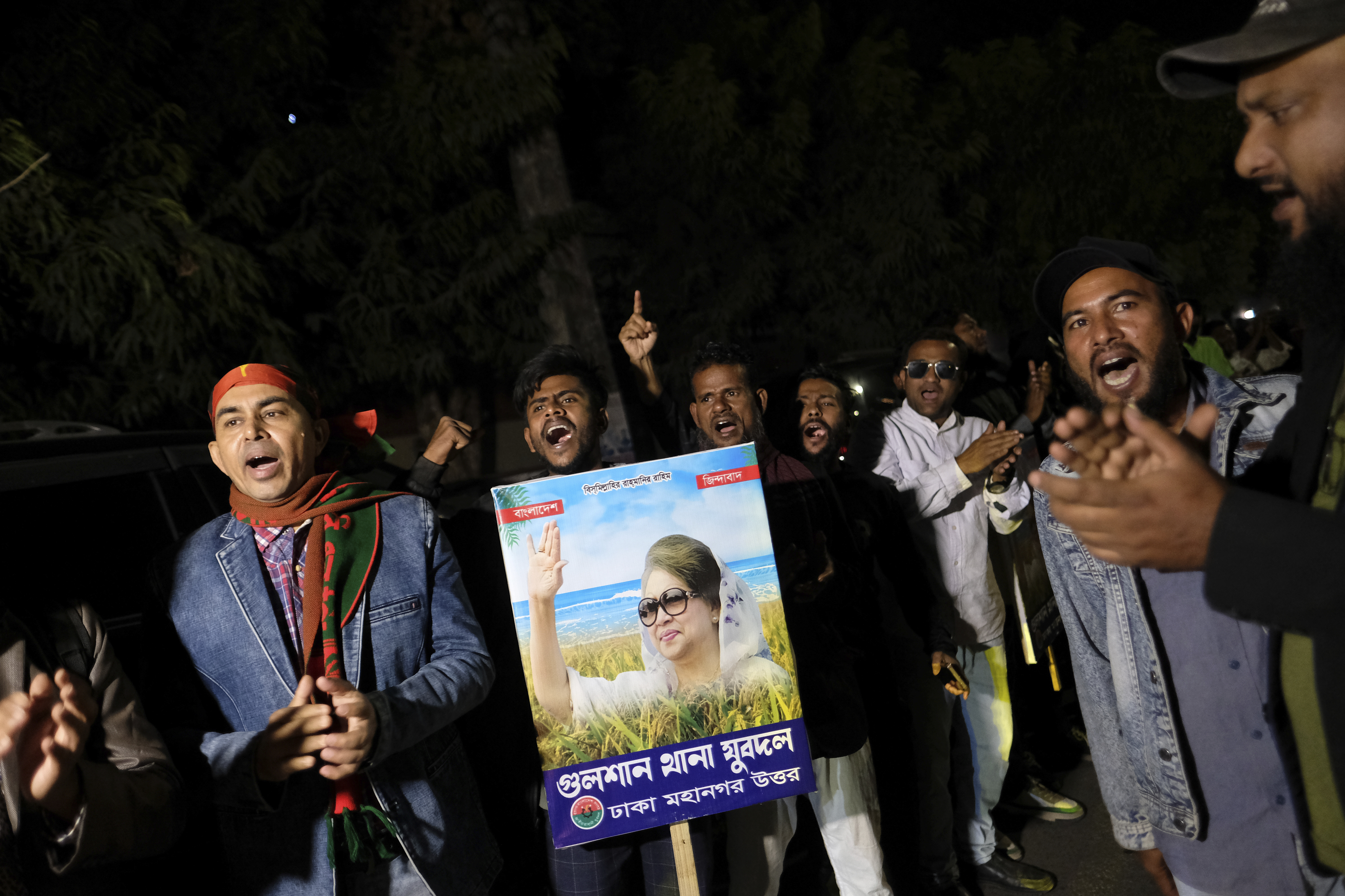 Supporters of Bangladesh's ailing former Prime Minister Khaleda Zia shout slogans before Zia left Dhaka, Bangladesh, to travel to London for medical treatment, Tuesday, Jan. 7, 2025. (AP Photo/Mahmud Hossain Opu)