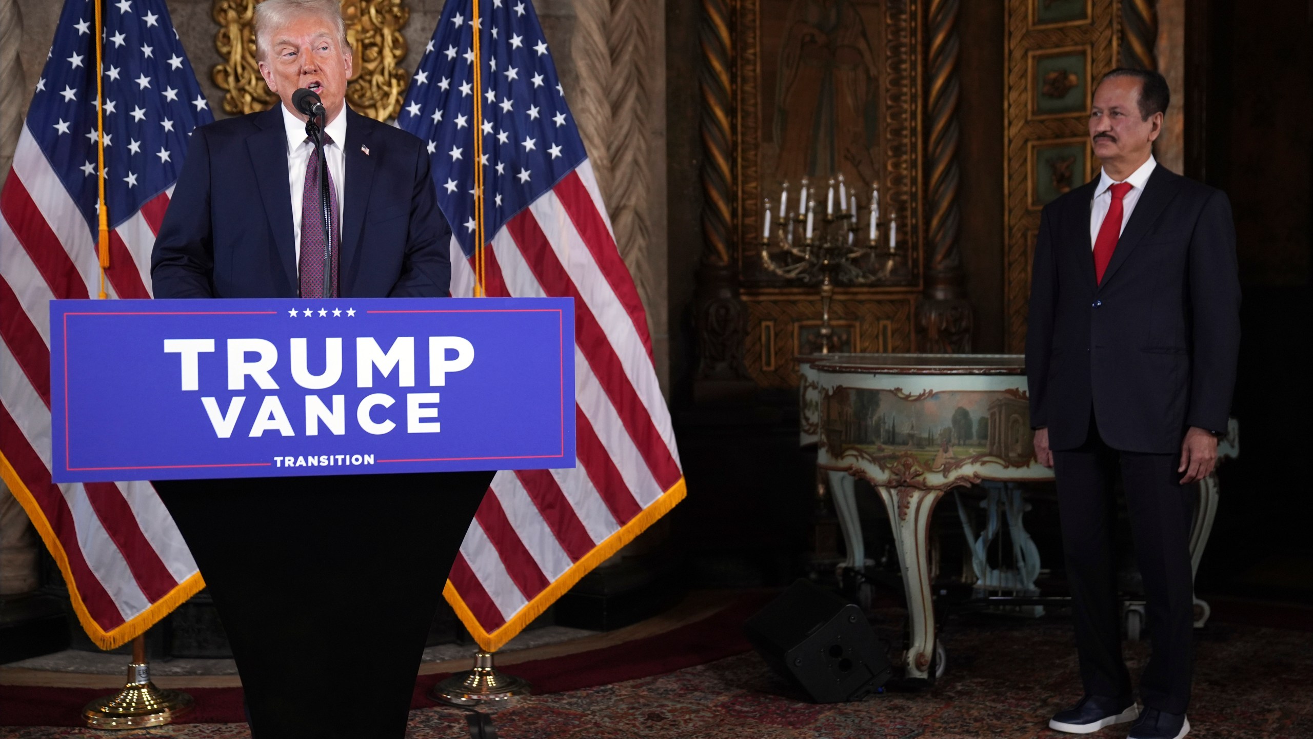 President-elect Donald Trump speaks as Hussain Sajwani, CEO of DAMAC Properties, listens during a news conference at Mar-a-Lago, Tuesday, Jan. 7, 2024, in Palm Beach, Fla. (AP Photo/Evan Vucci)