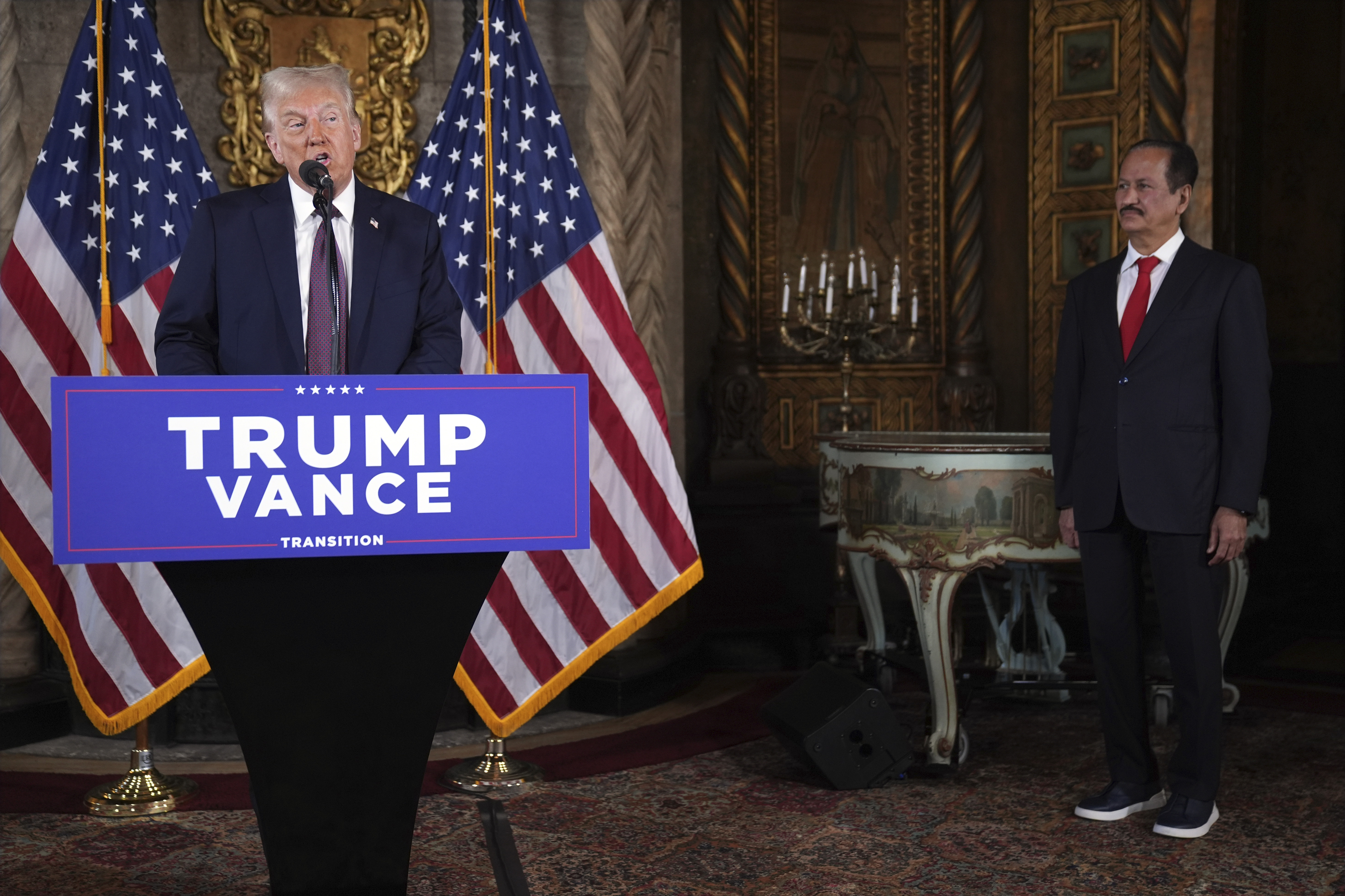 President-elect Donald Trump speaks as Hussain Sajwani, CEO of DAMAC Properties, listens during a news conference at Mar-a-Lago, Tuesday, Jan. 7, 2024, in Palm Beach, Fla. (AP Photo/Evan Vucci)