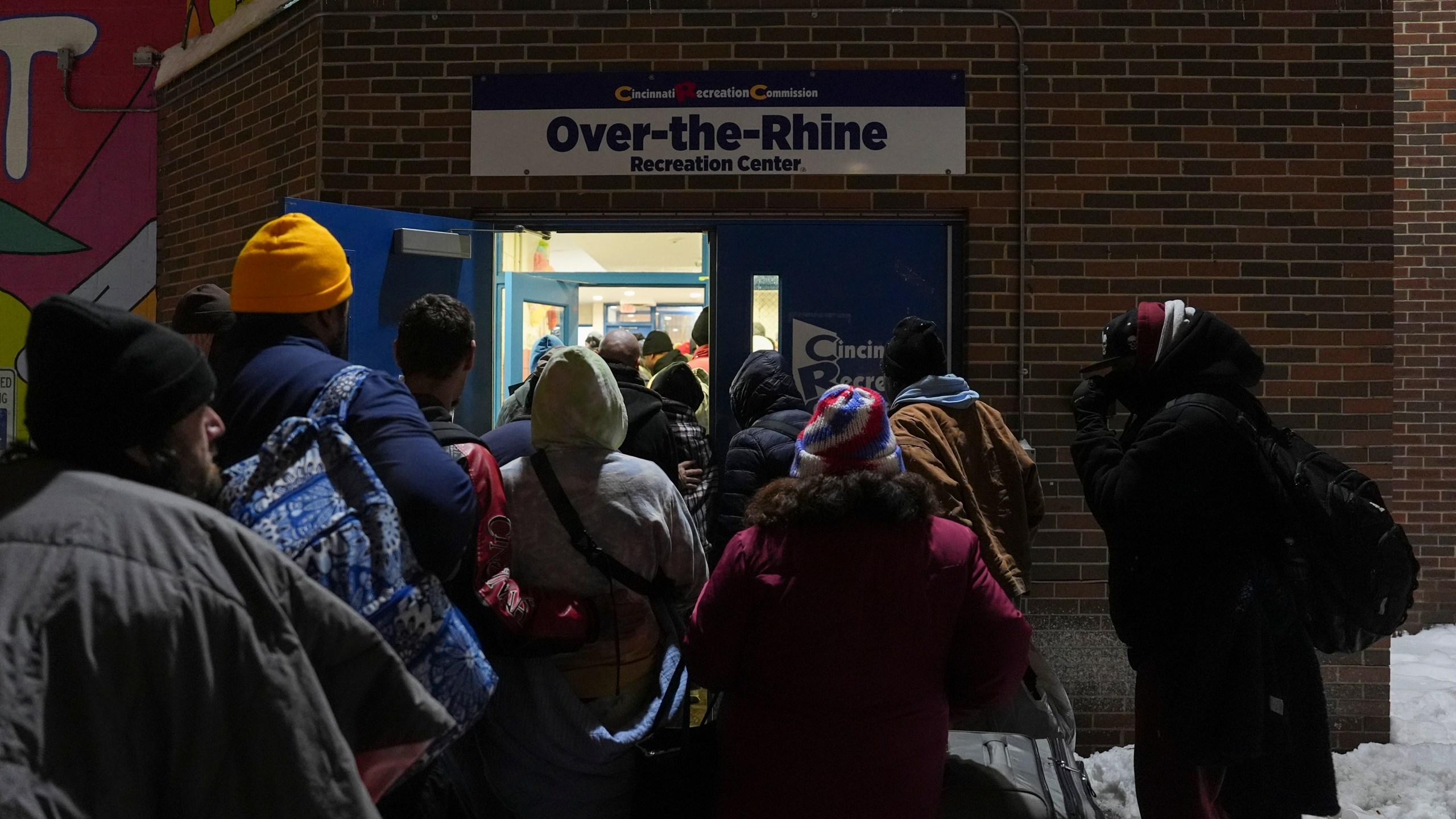 Patrons enter a daytime warming shelter as it opens for the day, Tuesday, Jan. 7, 2025, in Cincinnati. (AP Photo/Joshua A. Bickel)