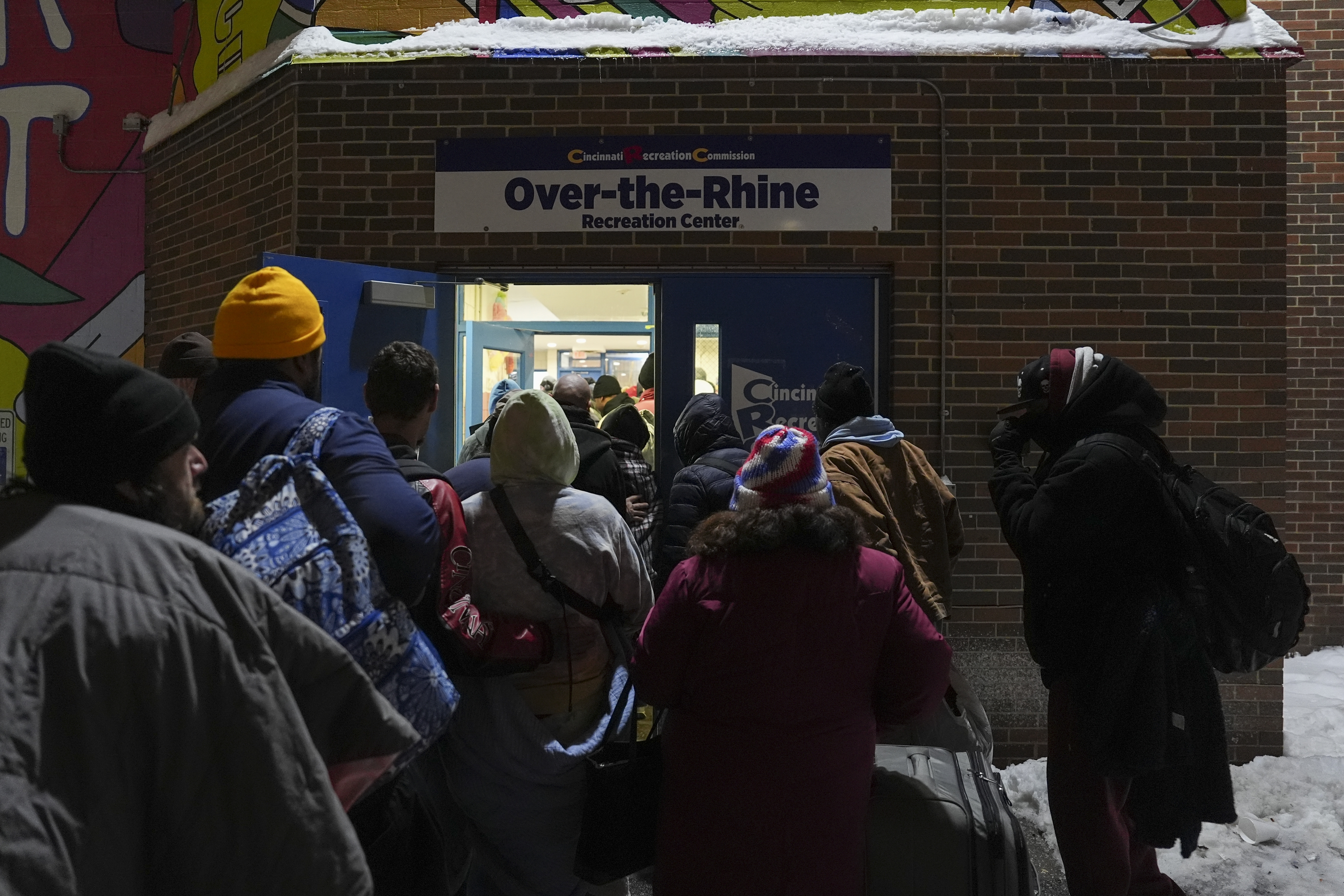 Patrons enter a daytime warming shelter as it opens for the day, Tuesday, Jan. 7, 2025, in Cincinnati. (AP Photo/Joshua A. Bickel)