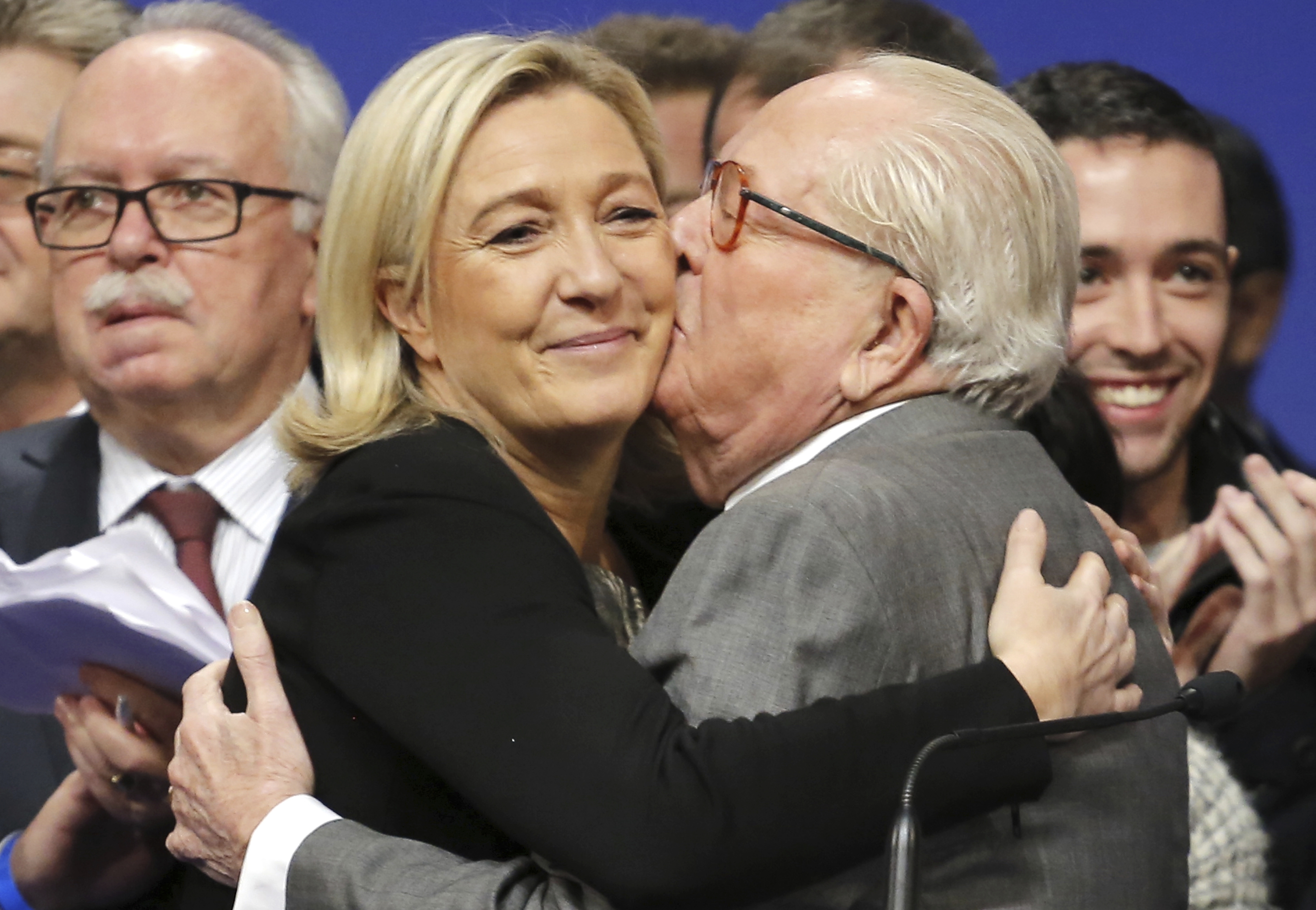 FILE - French far-right Front National leader Marine Le Pen is kissed by her father Jean-Marie Le Pen, in Lyon, central France, Sunday Nov. 30, 2014. (AP Photo/Laurent Cipriani, File)