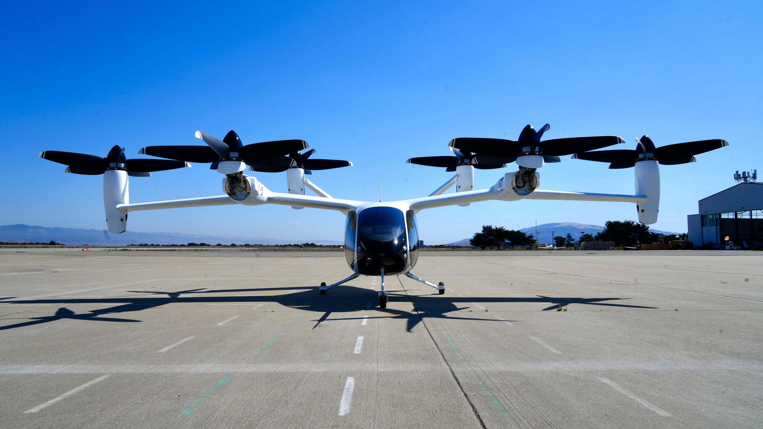 An "electric vertical take-off and landing" aircraft built by Joby Aviation is parked at an airfield in Marina, Calif. on Monday, Oct. 7, 2024. (AP Photo/Terry Chea)