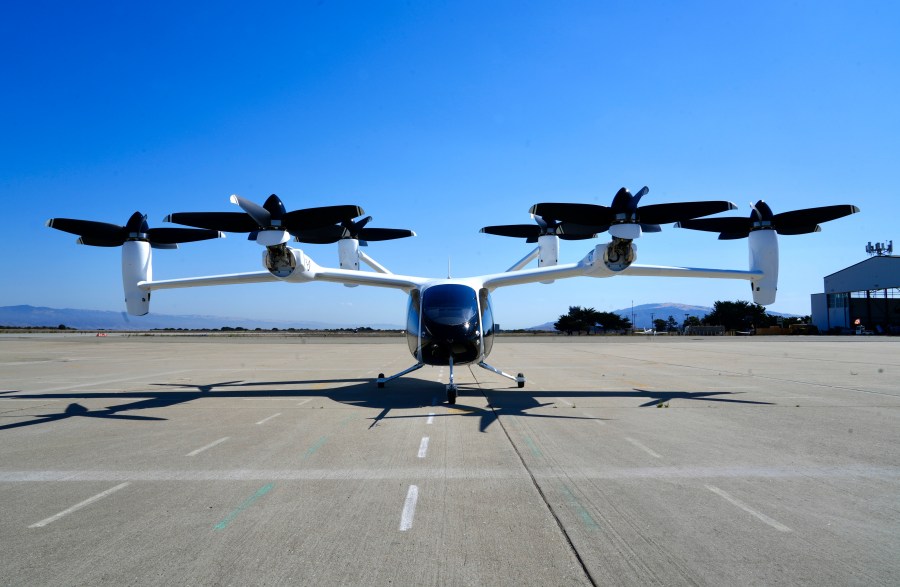 An "electric vertical take-off and landing" aircraft built by Joby Aviation is parked at an airfield in Marina, Calif. on Monday, Oct. 7, 2024. (AP Photo/Terry Chea)