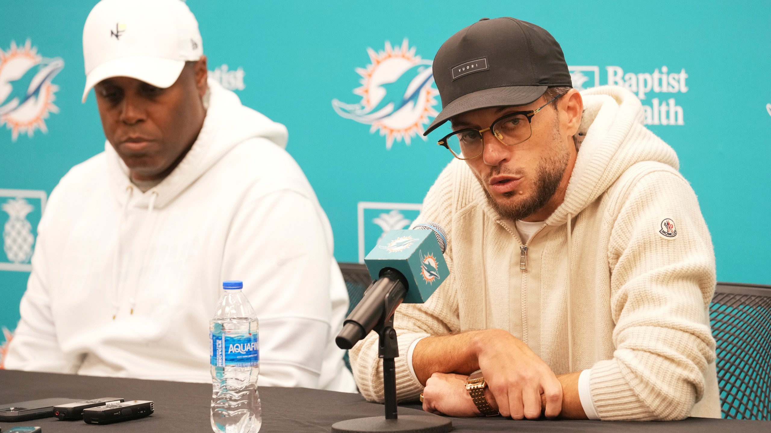 Miami Dolphins head coach Mike McDaniel speaks as general manager Chris Grier listens during a post season news conference, Tuesday, Jan. 7, 2025, in Miami Gardens, Fla. (AP Photo/Marta Lavandier)