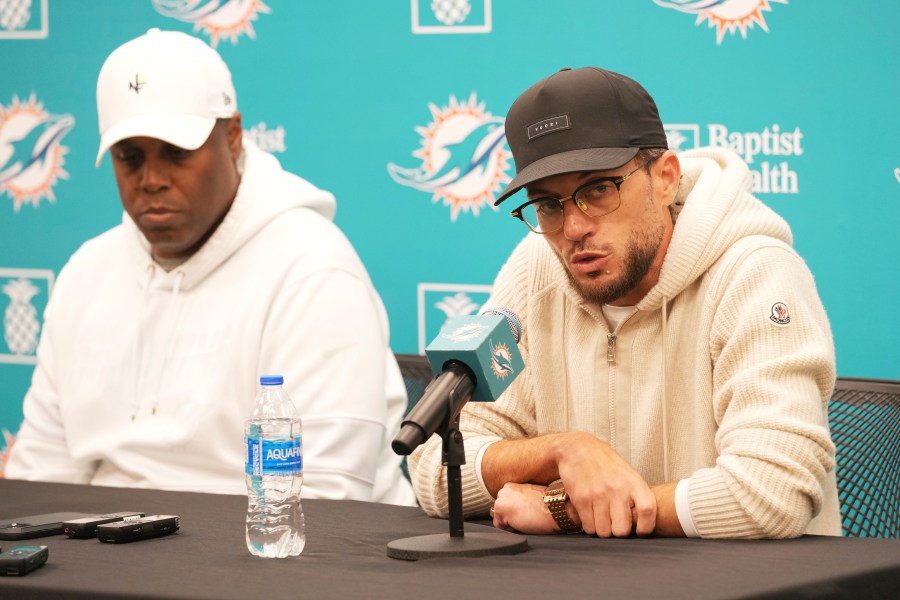 Miami Dolphins head coach Mike McDaniel speaks as general manager Chris Grier listens during a post season news conference, Tuesday, Jan. 7, 2025, in Miami Gardens, Fla. (AP Photo/Marta Lavandier)