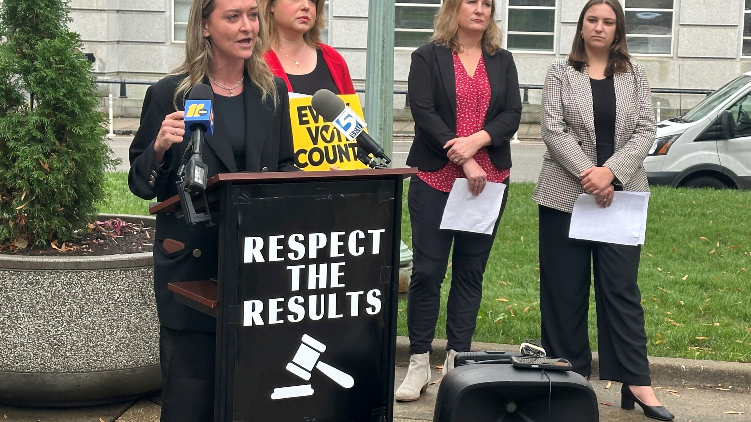 North Carolina state Democratic Party Chair Anderson Clayton, left, speaks at a news conference about the pending election for a state Supreme Court seat on Tuesday, Dec. 10, 2024, on Capitol Square in Raleigh, N.C. (AP Photo/Gary D. Robertson)