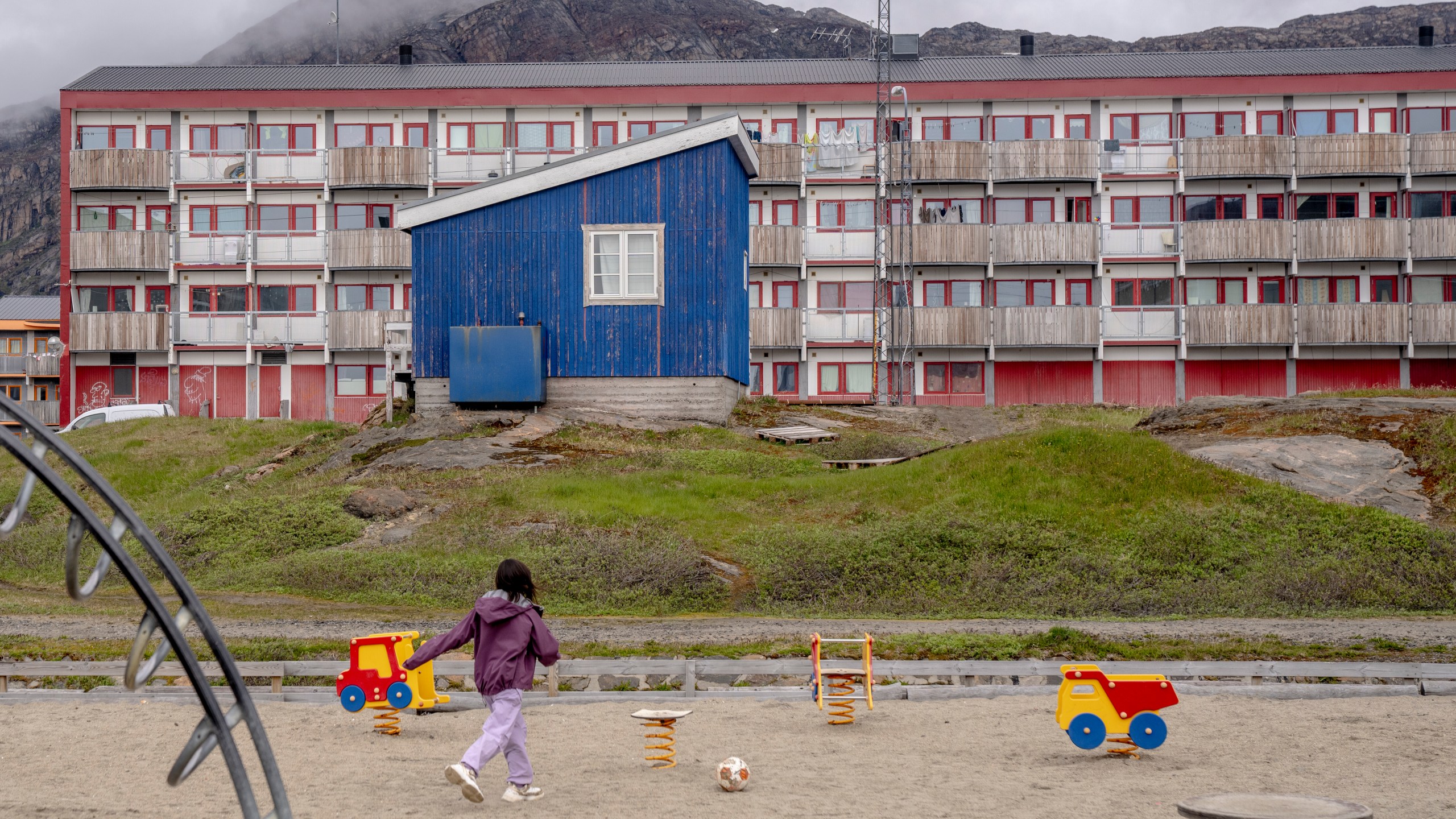 FILE - A child plays in front of a residential block in Sisimiut, Greenland, Tuesday, July 2, 2024. (Ida Marie Odgaard/Ritzau Scanpix via AP, File)