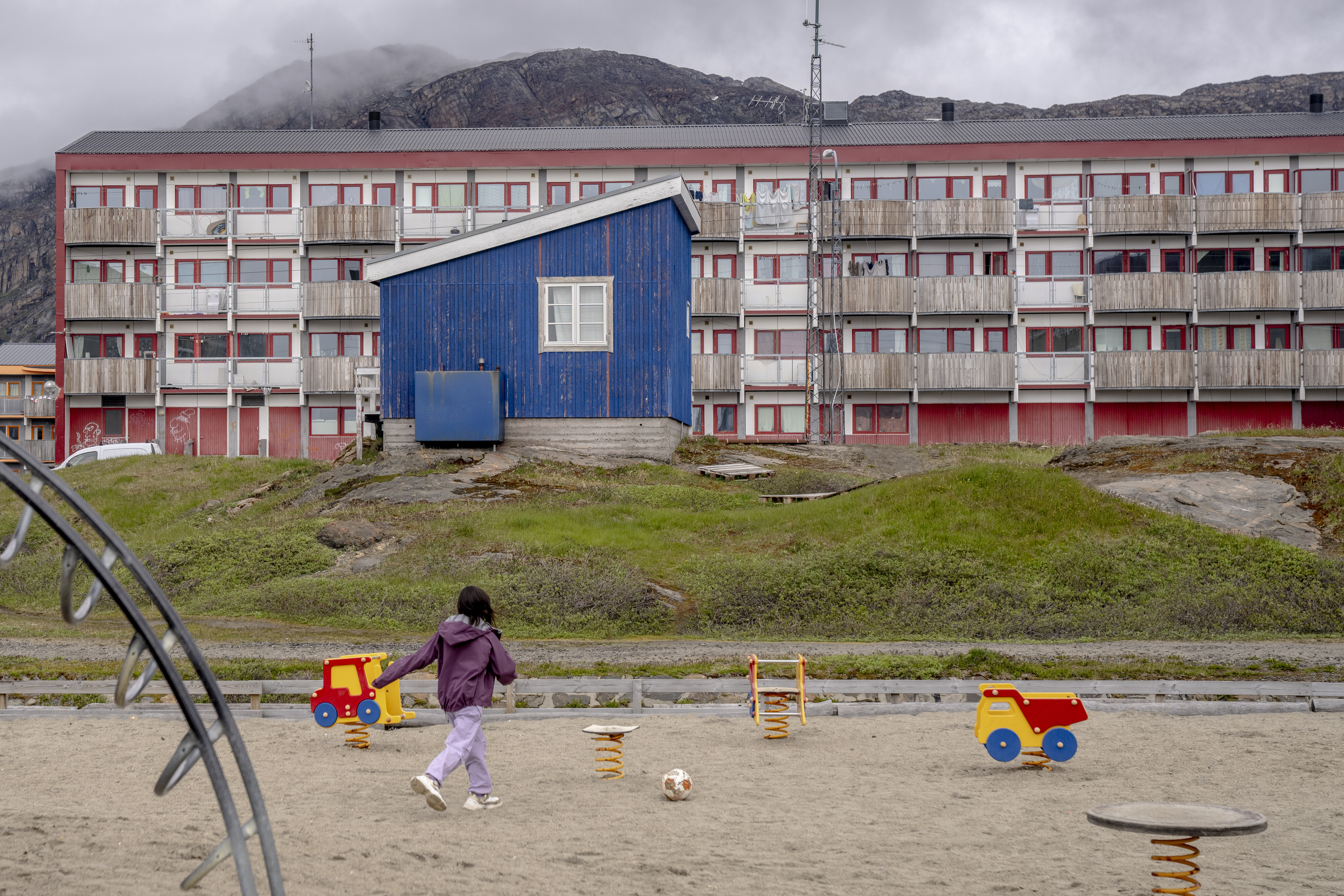 FILE - A child plays in front of a residential block in Sisimiut, Greenland, Tuesday, July 2, 2024. (Ida Marie Odgaard/Ritzau Scanpix via AP, File)