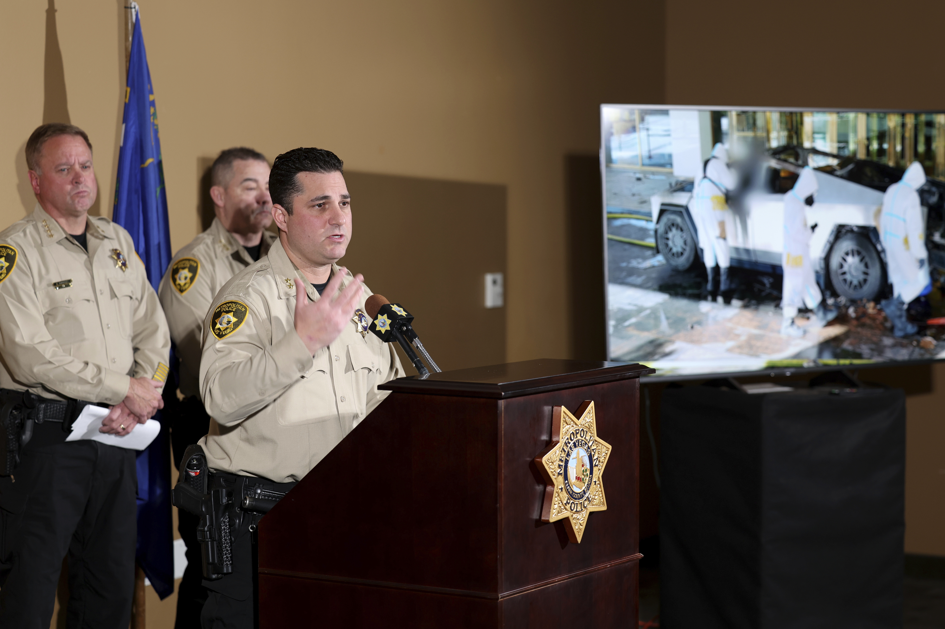 Metropolitan Police Department Assistant Sheriff Dori Koren shows a photo of the investigation into a Tesla Cybertruck that exploded at the Trump International Hotel, during a news conference at Metropolitan Police Department headquarters in Las Vegas, Tuesday, Jan. 7, 2025. (K.M. Cannon/Las Vegas Review-Journal via AP)