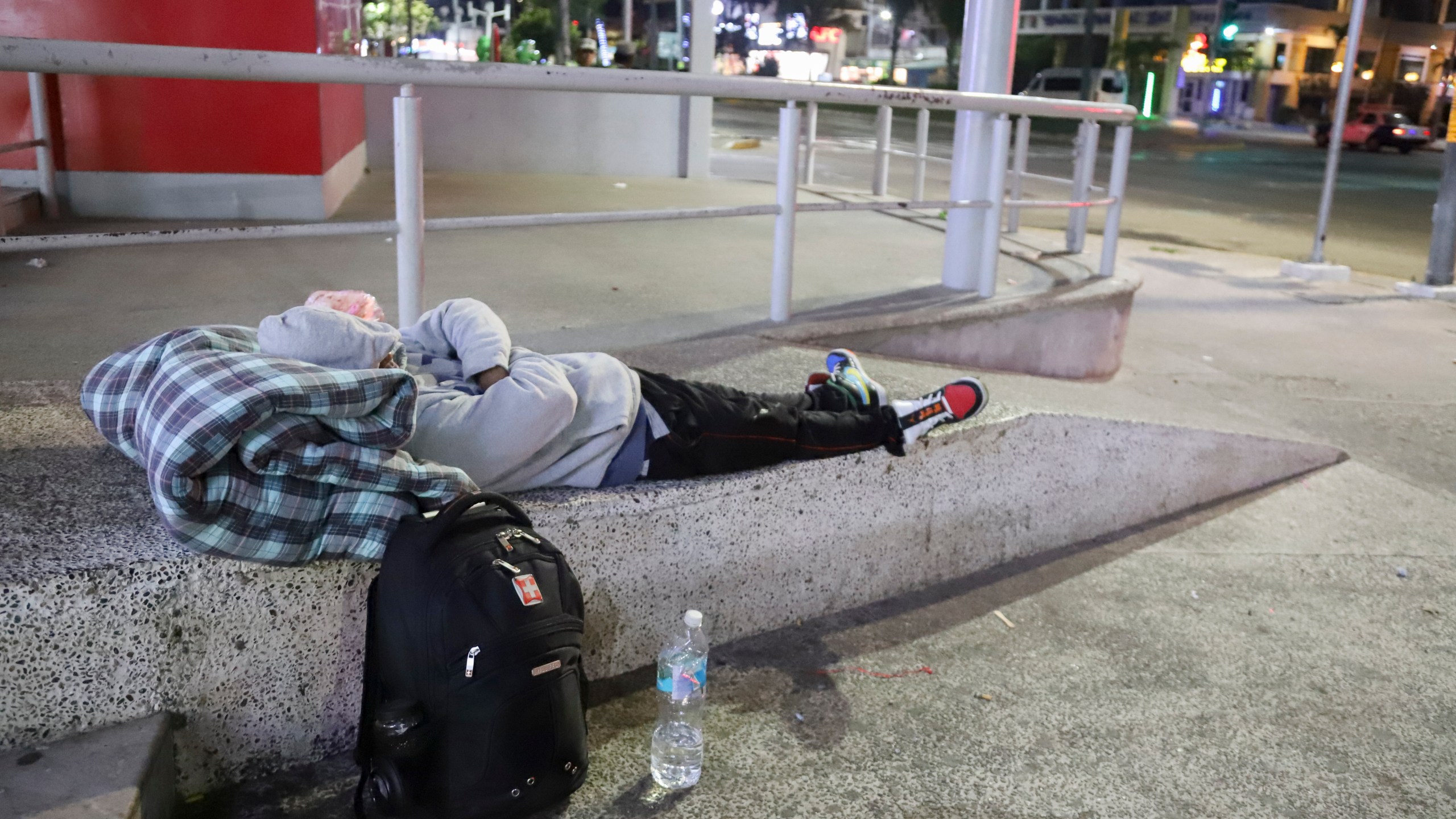 A migrant sleeps on the side of a street in Acapulco, Mexico, Monday, Jan. 6, 2025. (AP Photo/Bernardino Hernandez)