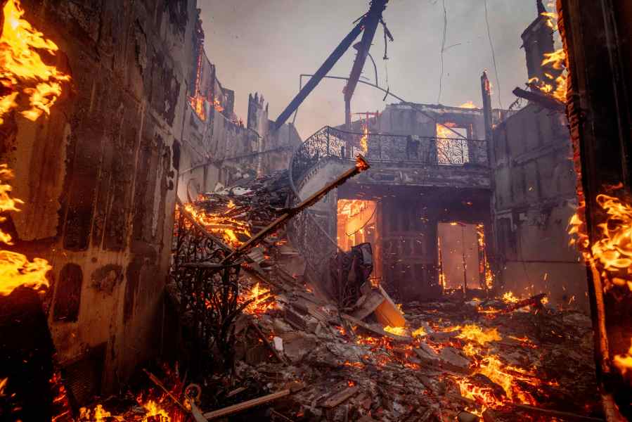 CORRECTS BYLINE FROM ETIENNE LAURENT TO ETHAN SWOPE - The Palisades Fire burns a residence in the Pacific Palisades neighborhood of Los Angeles, Tuesday, Jan. 7, 2025. (AP Photo/Ethan Swope)