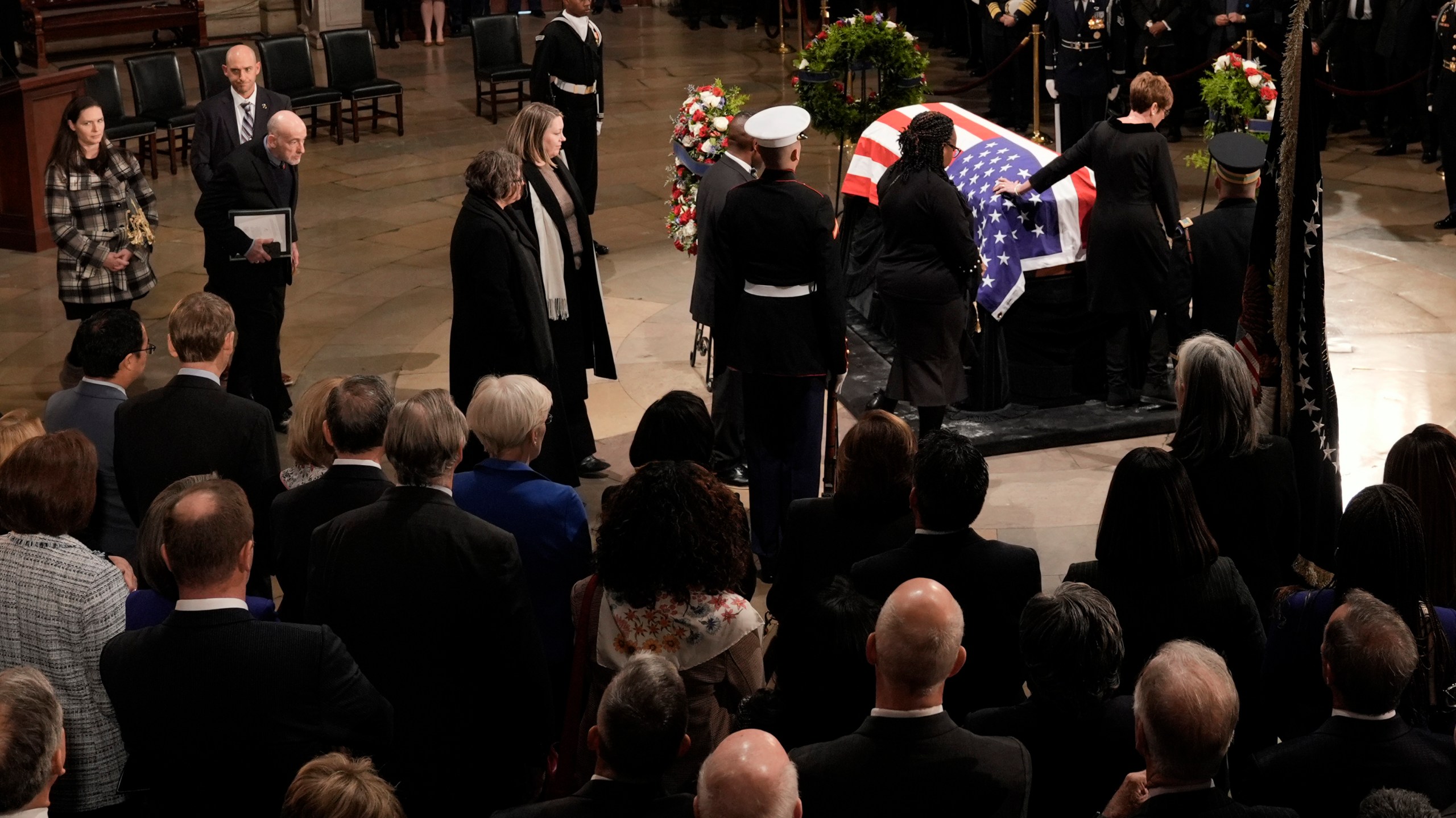 Members of the Carter family pay their respects as the flag-draped casket of former President Jimmy Carter lies in state at the U.S. Capitol, Tuesday, Jan. 7, 2025, in Washington. Carter died Dec. 29 at the age of 100. (AP Photo/J. Scott Applewhite, Pool)