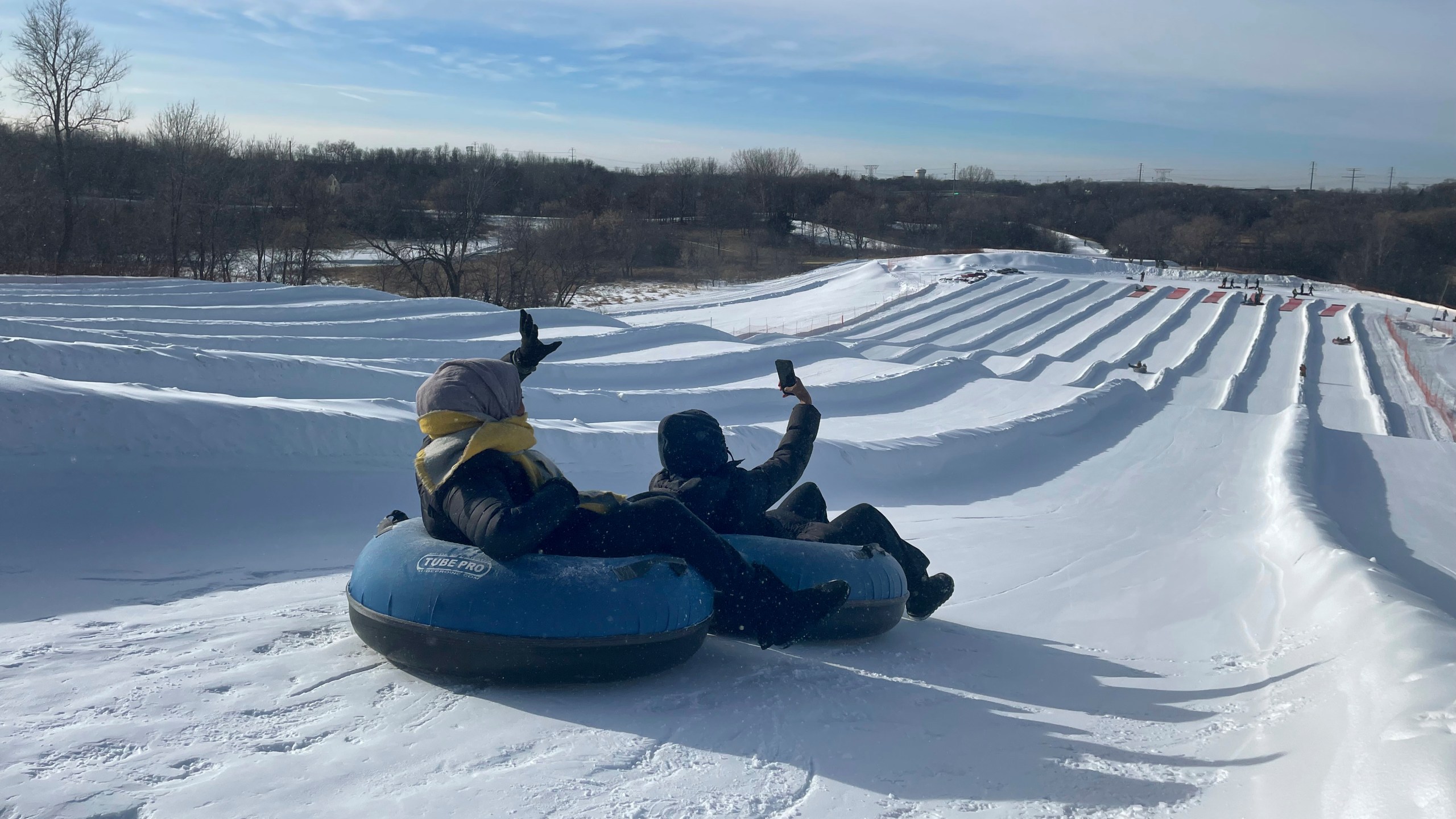 Sisters Ruun Mahamud, left, and Nawal Hirsi go snow tubing during an outing organized by the group Habib founded to promote outdoors activities among Muslim women, at Elm Creek Park Reserve in Maple Grove, Minn., on Jan. 4, 2025. (AP Photo/Giovanna Dell'Orto)