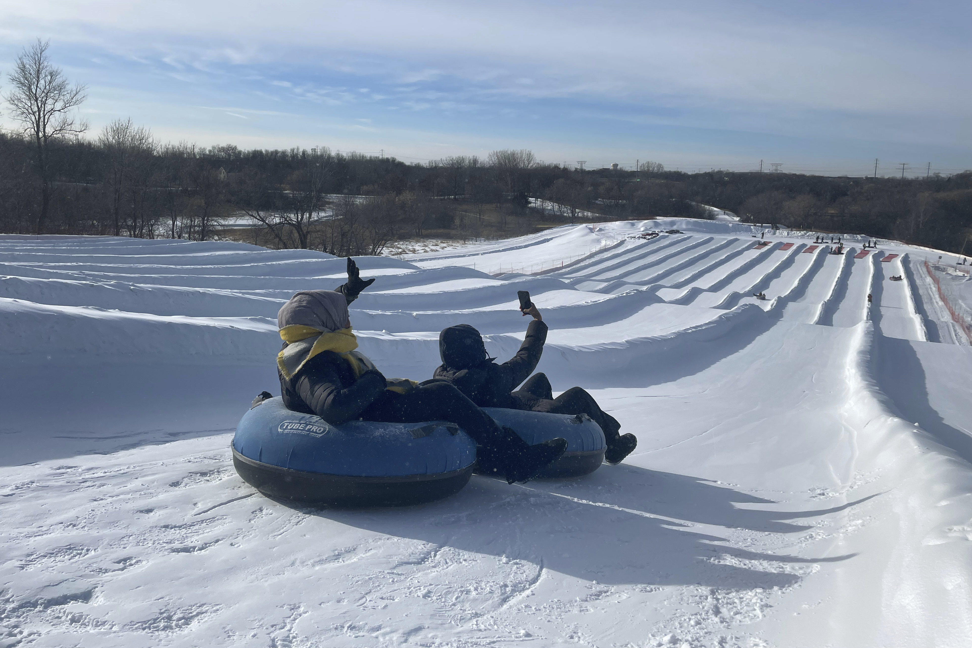 Sisters Ruun Mahamud, left, and Nawal Hirsi go snow tubing during an outing organized by the group Habib founded to promote outdoors activities among Muslim women, at Elm Creek Park Reserve in Maple Grove, Minn., on Jan. 4, 2025. (AP Photo/Giovanna Dell'Orto)