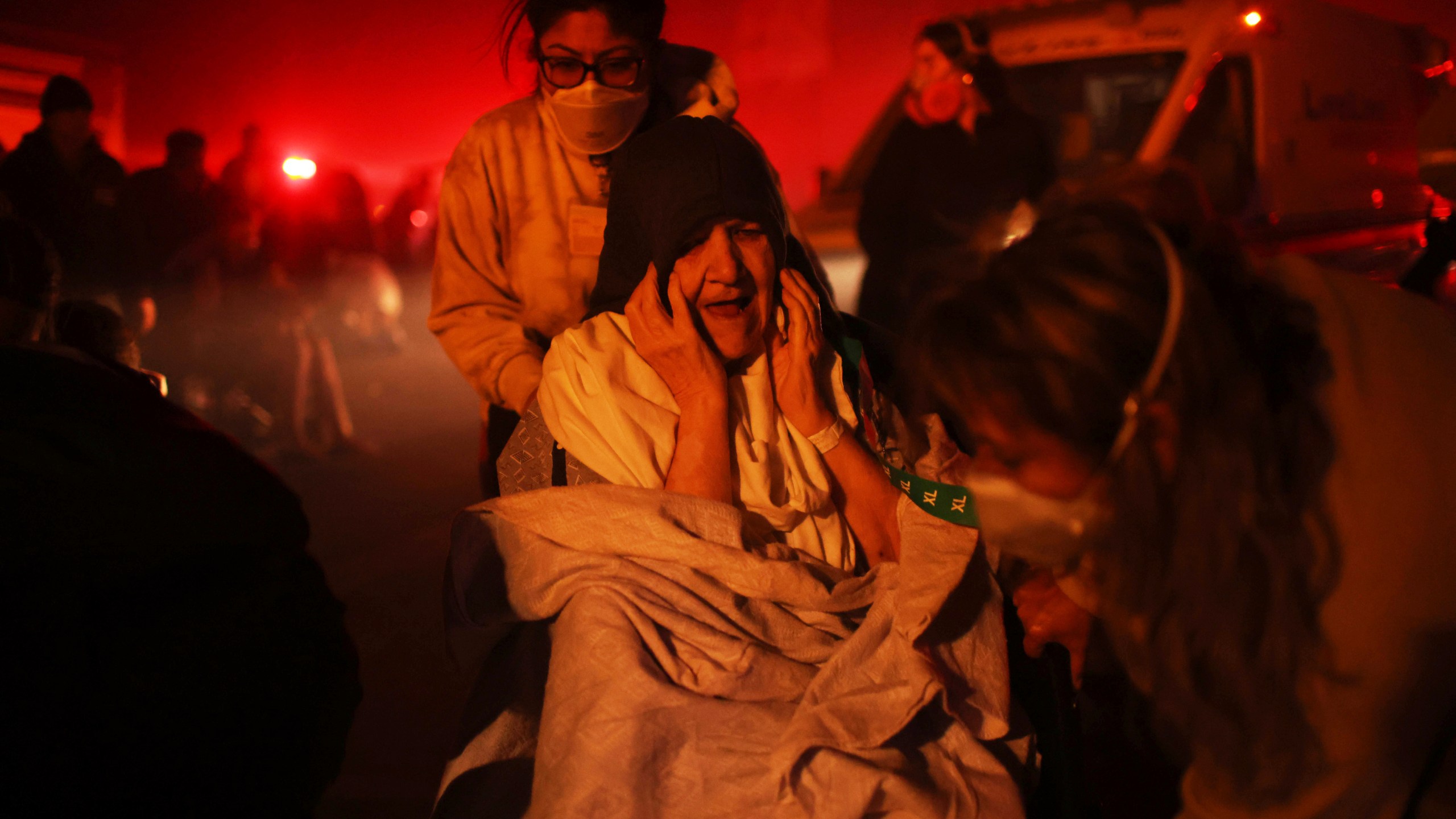 A resident of a senior center is evacuated as the Eaton Fire approaches Tuesday, Jan. 7, 2025 in Altadena, Calif. (AP Photo/Ethan Swope)