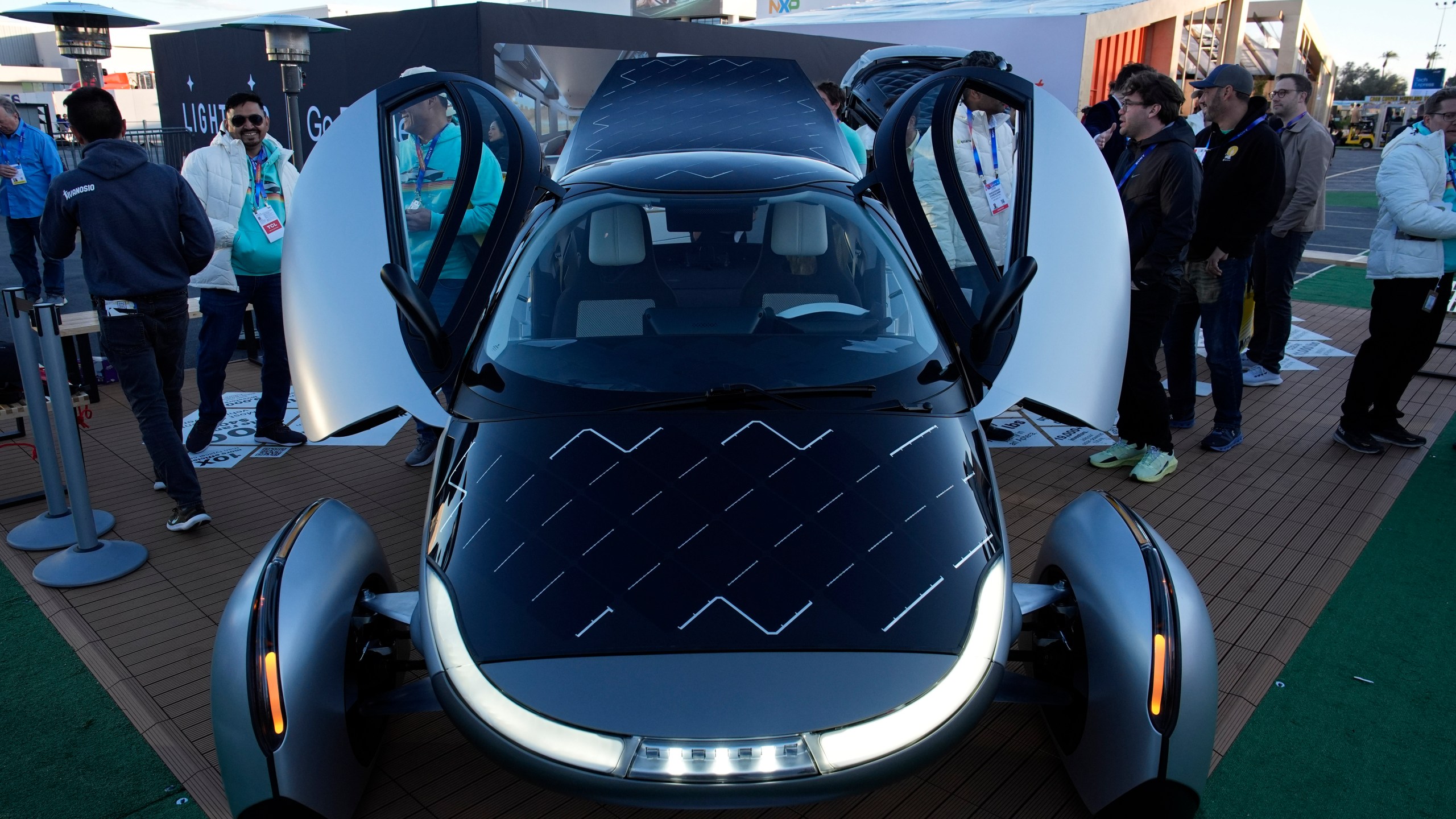 People look at a prototype solar electric vehicle by Aptera Motors during the CES tech show Tuesday, Jan. 7, 2025, in Las Vegas. (AP Photo/John Locher)