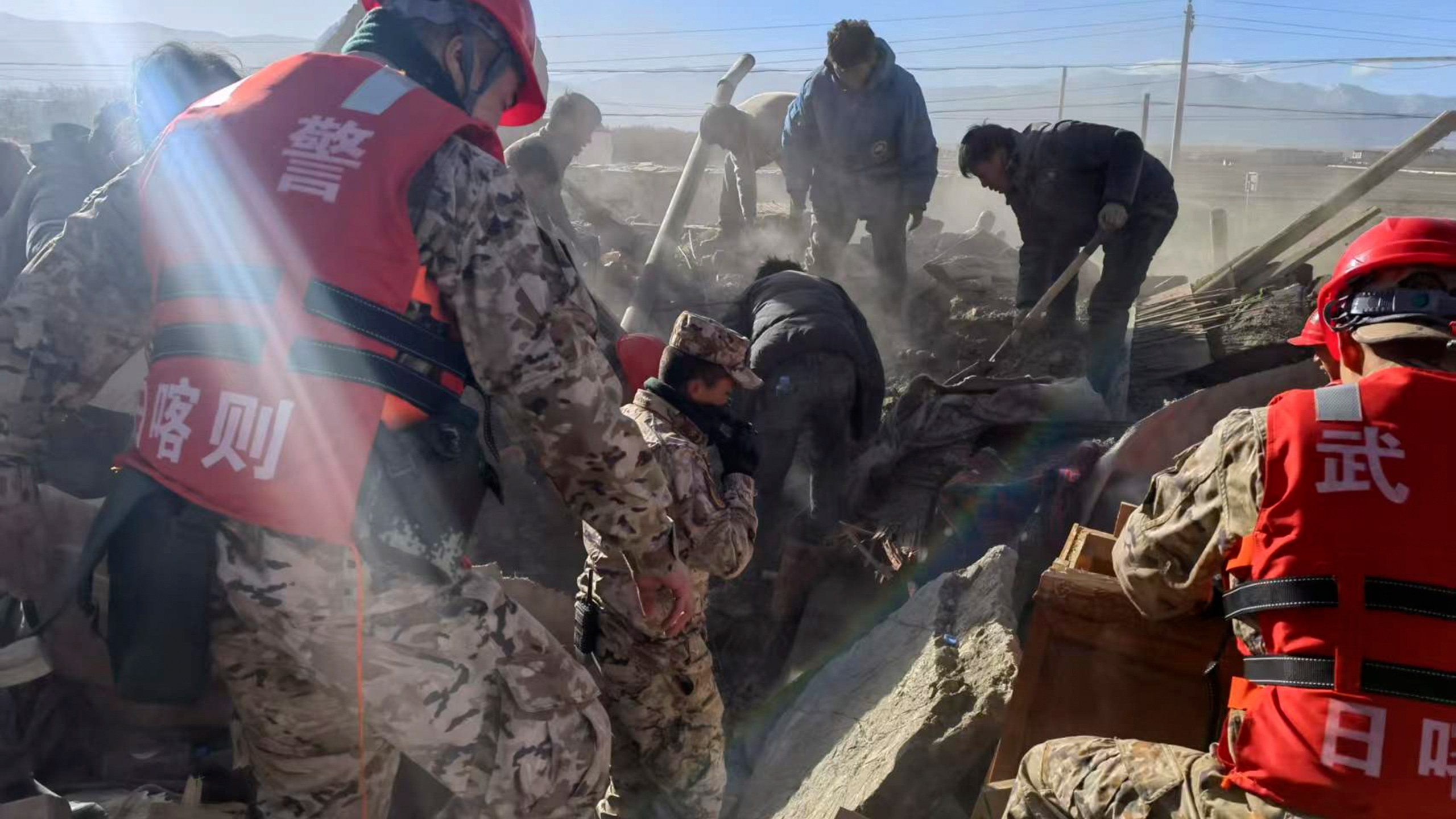 In this photo released by Xinhua News Agency, rescue workers conduct search and rescue for survivors in the aftermath of an earthquake in Changsuo Township of Dingri in Xigaze, southwestern China's Tibet Autonomous Region on Tuesday, Jan. 7, 2025. (Liu Yousheng/Xinhua via AP)