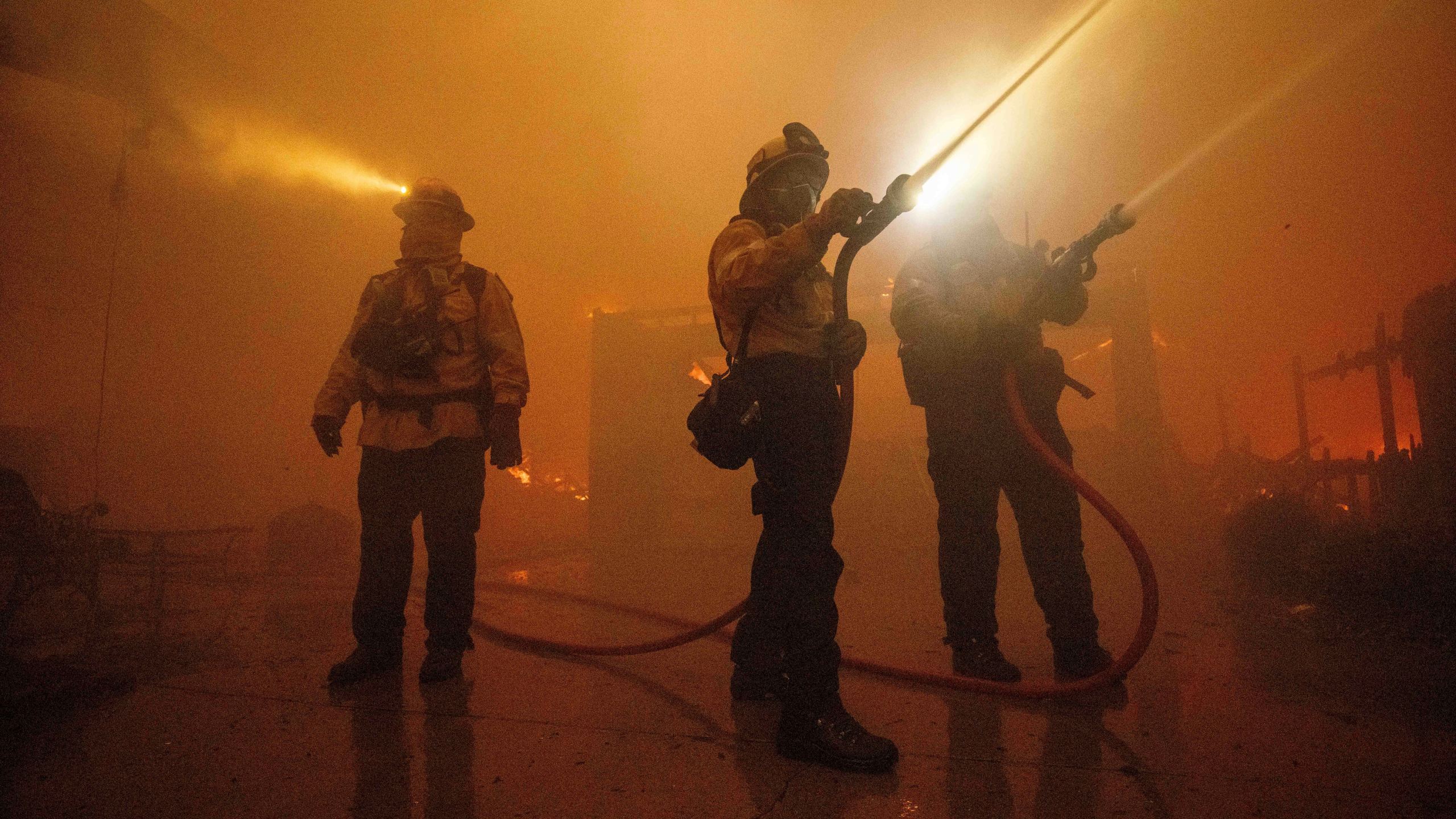 Fire crews battle the Eaton Fire Wednesday, Jan. 8, 2025 in Altadena, Calif. (AP Photo/Ethan Swope)