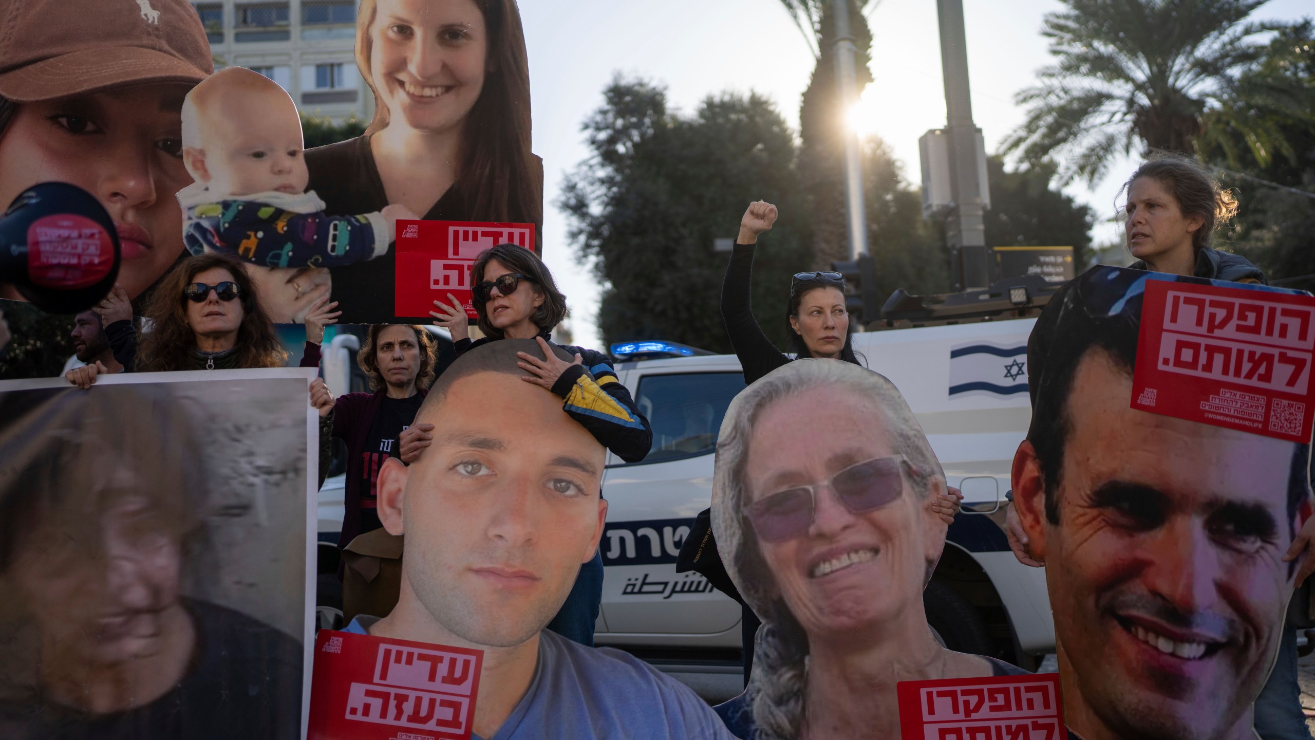 Relatives and supporters of Israeli hostages held by Hamas in Gaza hold photos of their loved ones during a protest calling for their return, in Tel Aviv, Israel, Wednesday, Jan. 8, 2025. (AP Photo/Ohad Zwigenberg)