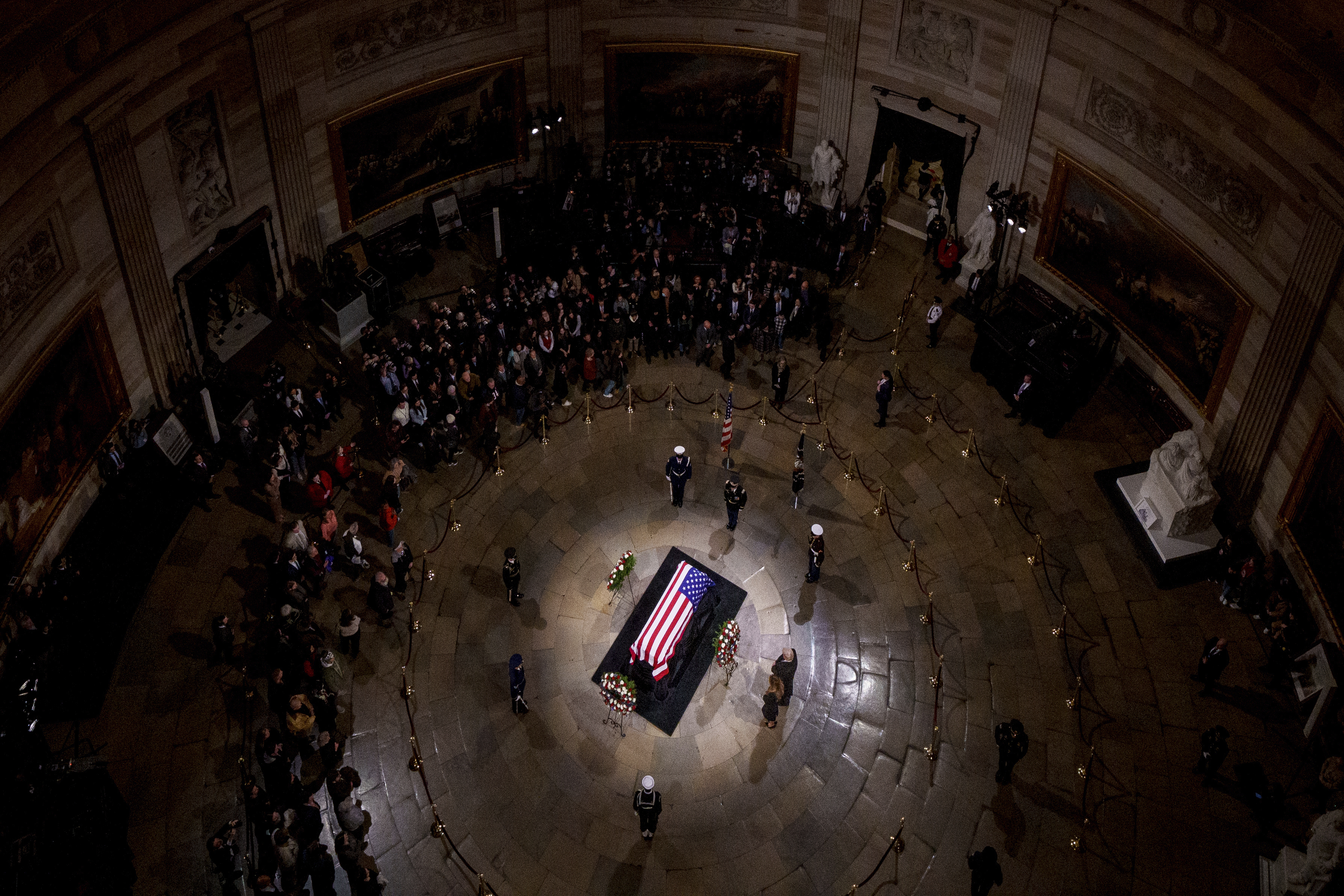 President-elect Donald Trump and Melania Trump pause at the flag-draped casket of former President Jimmy Carter as he lies in state in the rotunda of the U.S. Capitol in Washington, Wednesday, Jan. 8, 2025. (Andrew Harnik/Pool via AP)