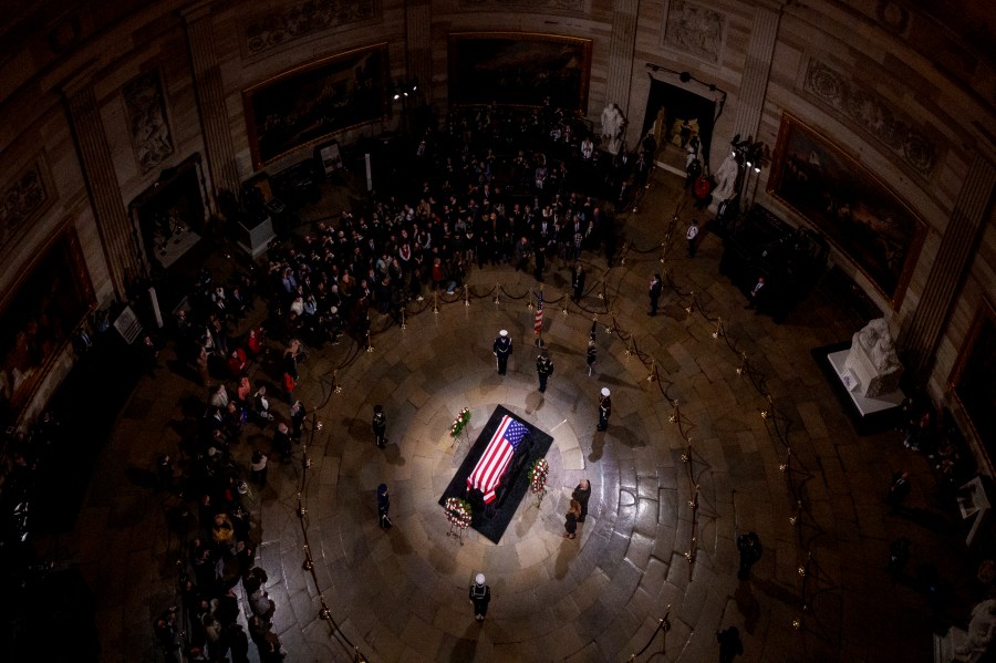 President-elect Donald Trump and Melania Trump pause at the flag-draped casket of former President Jimmy Carter as he lies in state in the rotunda of the U.S. Capitol in Washington, Wednesday, Jan. 8, 2025. (Andrew Harnik/Pool via AP)