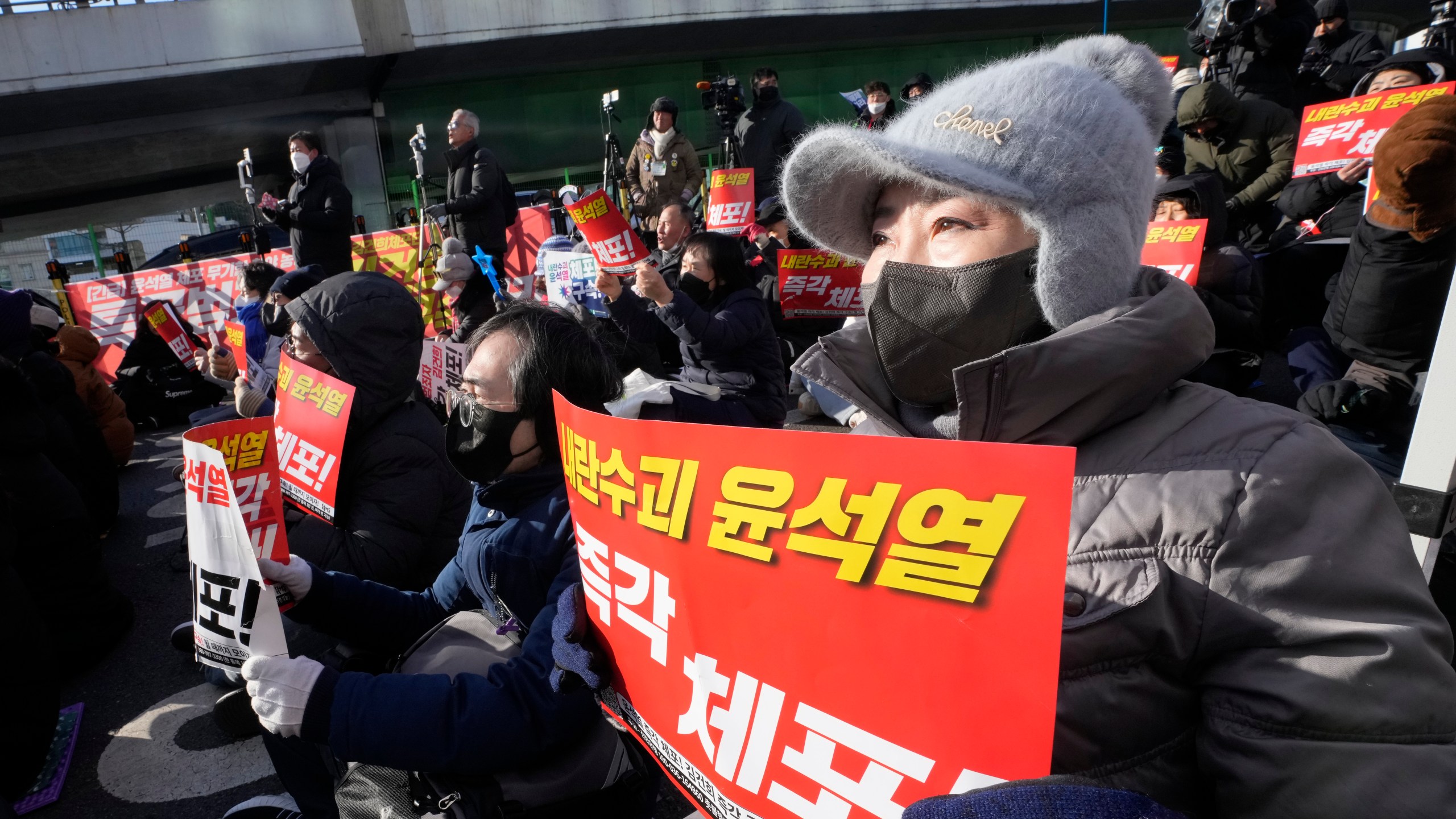 Protesters attend a rally demanding the arrest of impeached South Korean President Yoon Suk Yeol near the presidential residence in Seoul, South Korea, Thursday, Jan. 9, 2025. The letters read "Arrest Yoon Suk Yeol." (AP Photo/Ahn Young-joon)