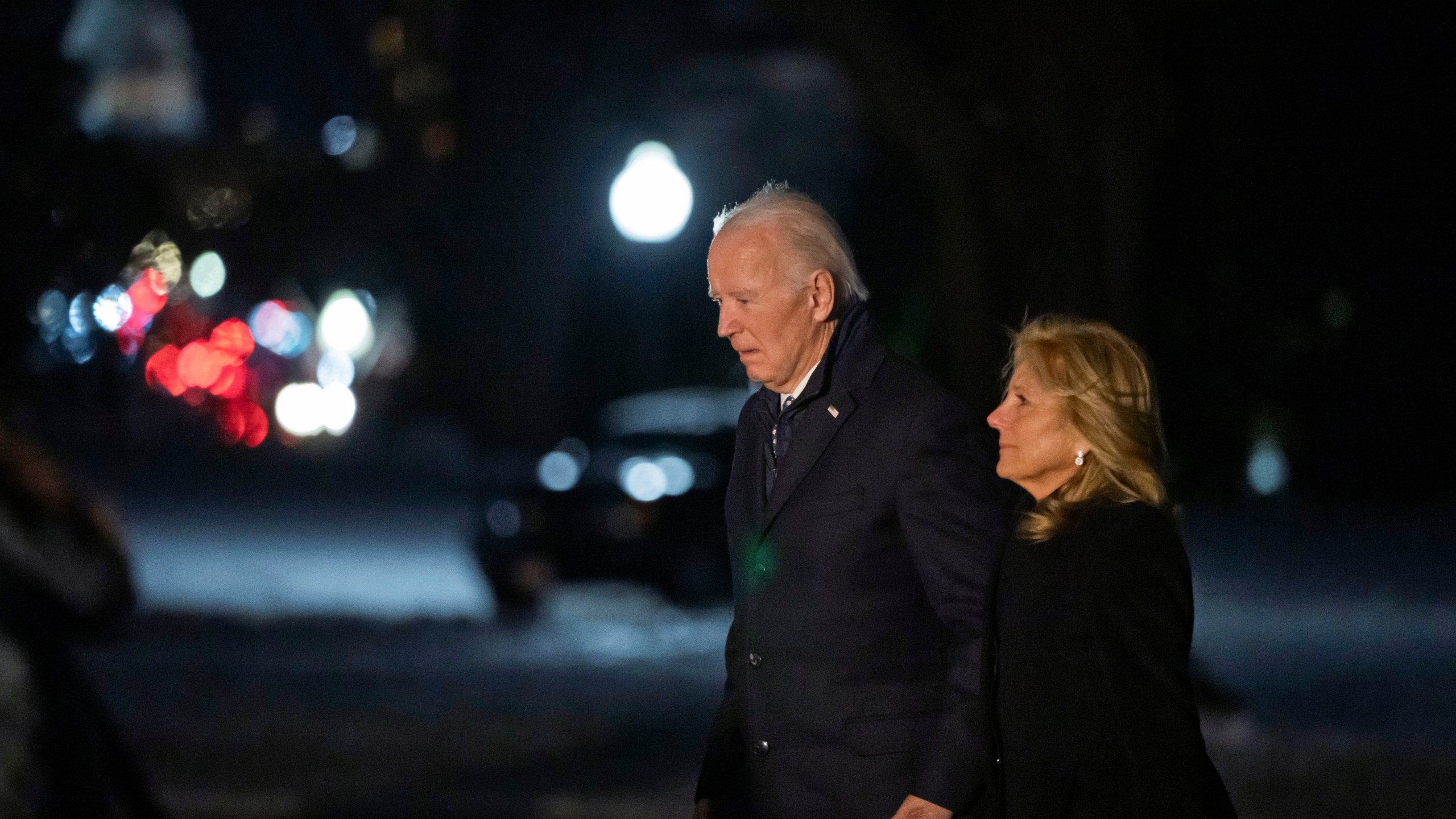 President Joe Biden and first lady Jill Biden walk from Marine One as they arrive back at the South Lawn of the White House in Washington, Wednesday, Jan. 8, 2025. (AP Photo/Ben Curtis)