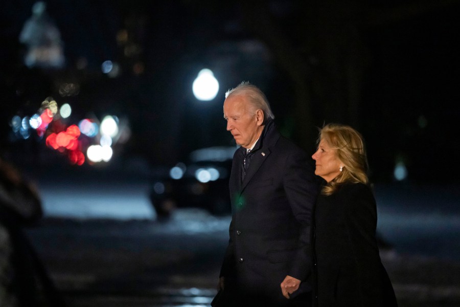 President Joe Biden and first lady Jill Biden walk from Marine One as they arrive back at the South Lawn of the White House in Washington, Wednesday, Jan. 8, 2025. (AP Photo/Ben Curtis)