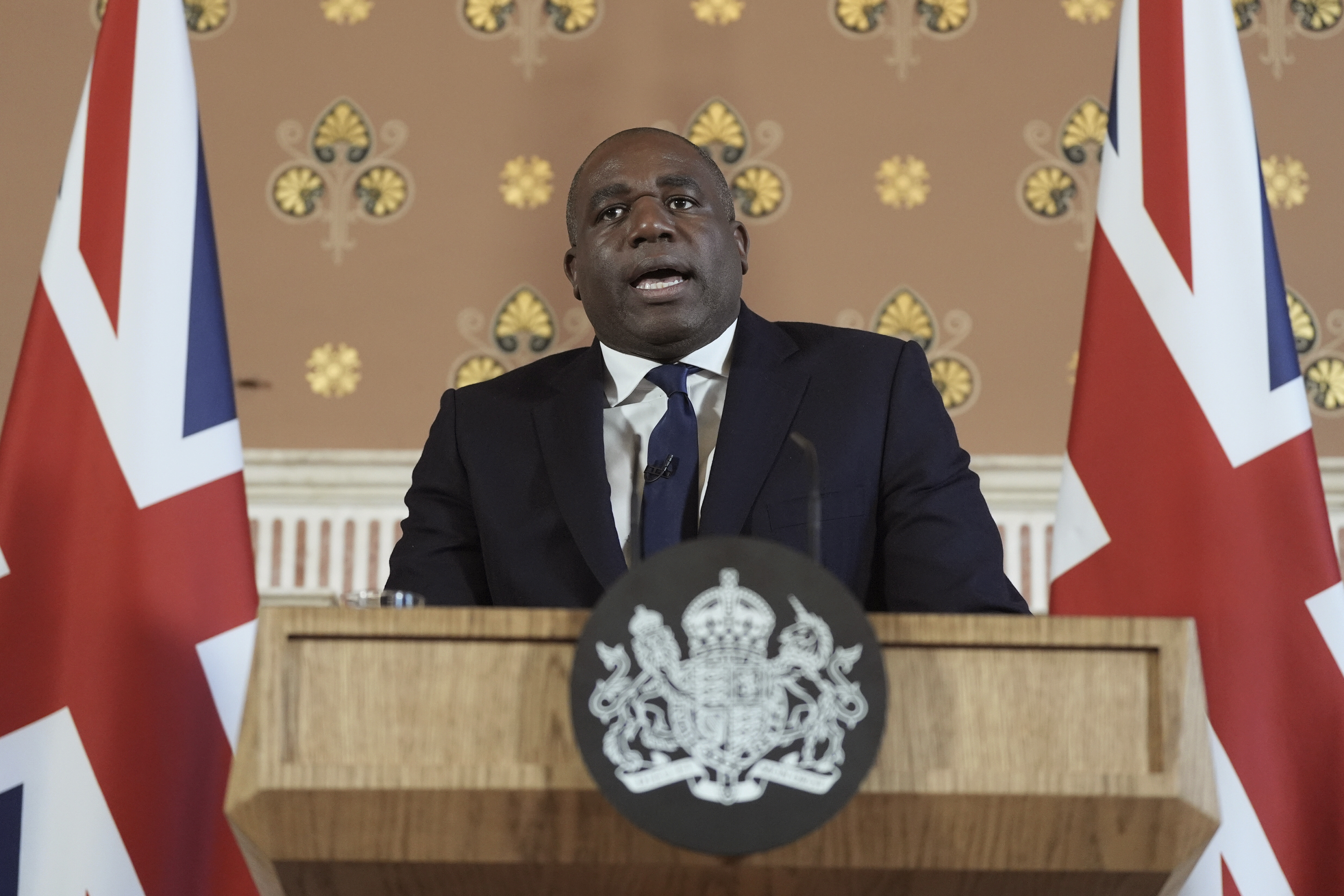 Britain's Foreign Secretary David Lammy delivers a speech on the government plans for new sanctions which will target the finances of people smuggling networks as part of efforts to stop migrants crossing the English Channel, in London, Thursday, Jan. 9, 2025. (Stefan Rousseau/Pool Photo via AP)