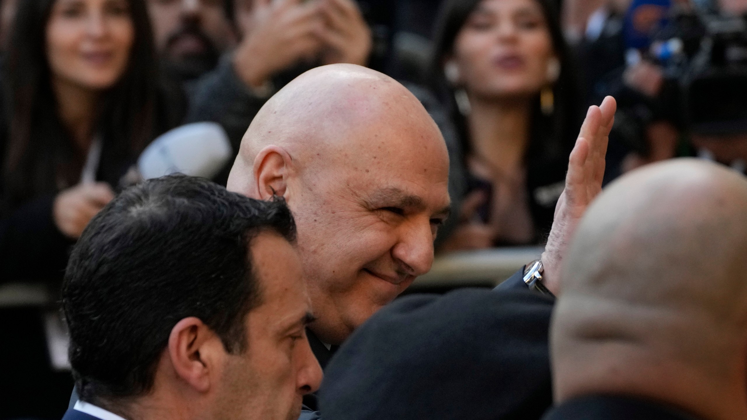 Newly-elected Lebanese President Joseph Aoun, center, smiles and waves to journalists upon his arrival at the Lebanese Parliament to be sworn in as a new president, in Beirut, Lebanon, Thursday, Jan. 9, 2025. (AP Photo/Hussein Malla)