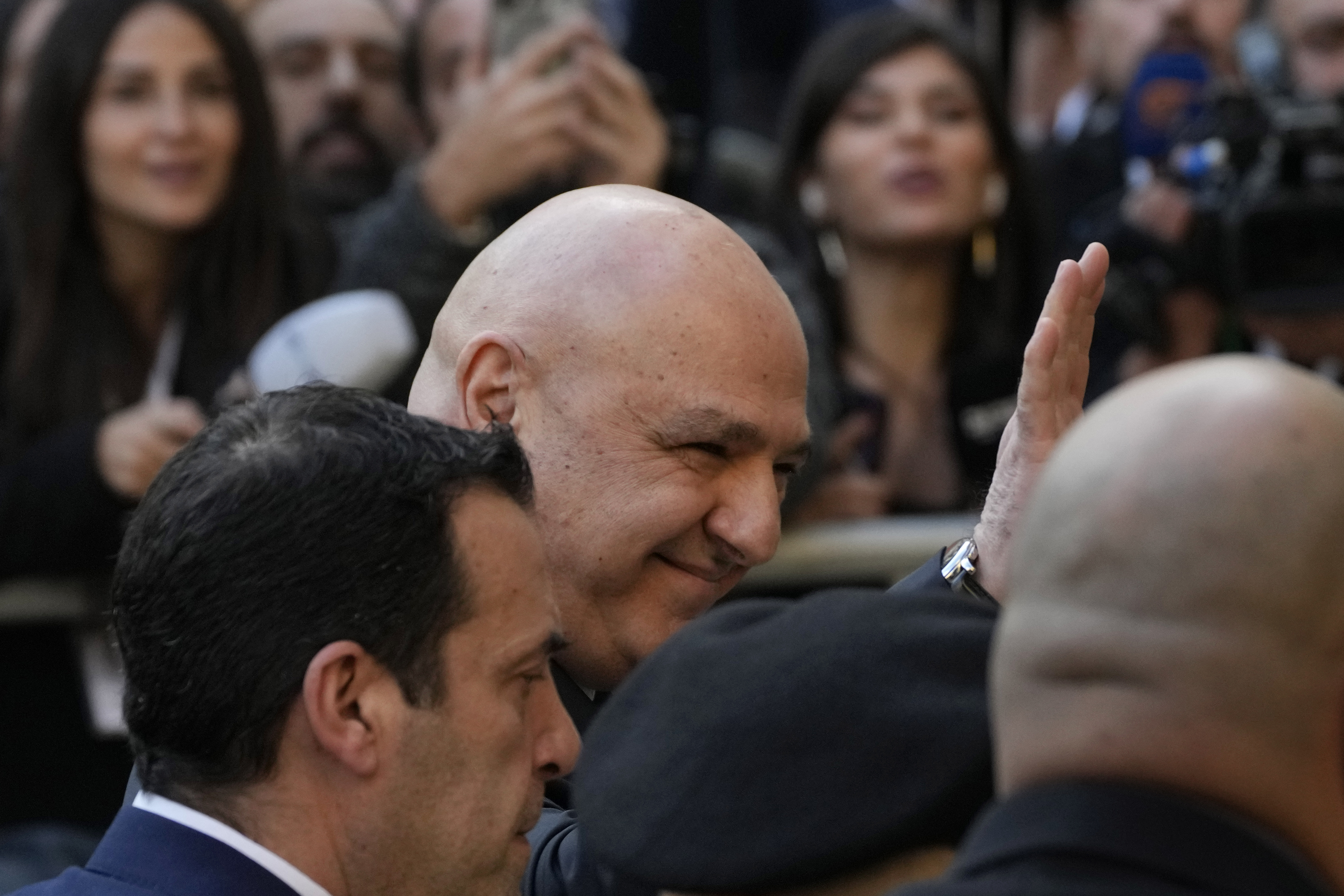 Newly-elected Lebanese President Joseph Aoun, center, smiles and waves to journalists upon his arrival at the Lebanese Parliament to be sworn in as a new president, in Beirut, Lebanon, Thursday, Jan. 9, 2025. (AP Photo/Hussein Malla)