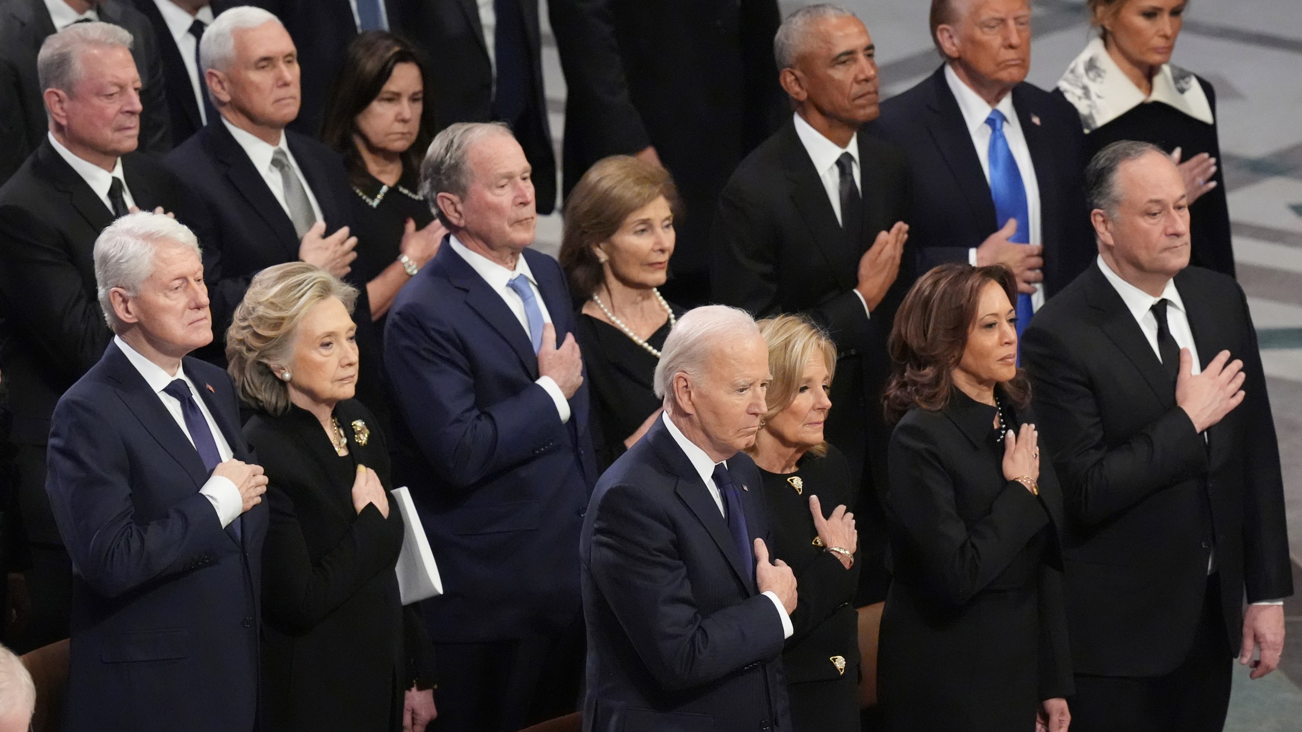 Front row, from left, President Joe Biden, first lady Jill Biden, Vice President Kamala Harris and second gentleman Doug Emhoff and second row from left, former President Bill Clinton, former Secretary of State Hillary Clinton, former President George W. Bush, Laura Bush, former President Barack Obama, President-elect Donald Trump and Melania Trump, stand during the state funeral for former President Jimmy Carter at Washington National Cathedral in Washington, Thursday, Jan. 9, 2025. (AP Photo/Jacquelyn Martin)