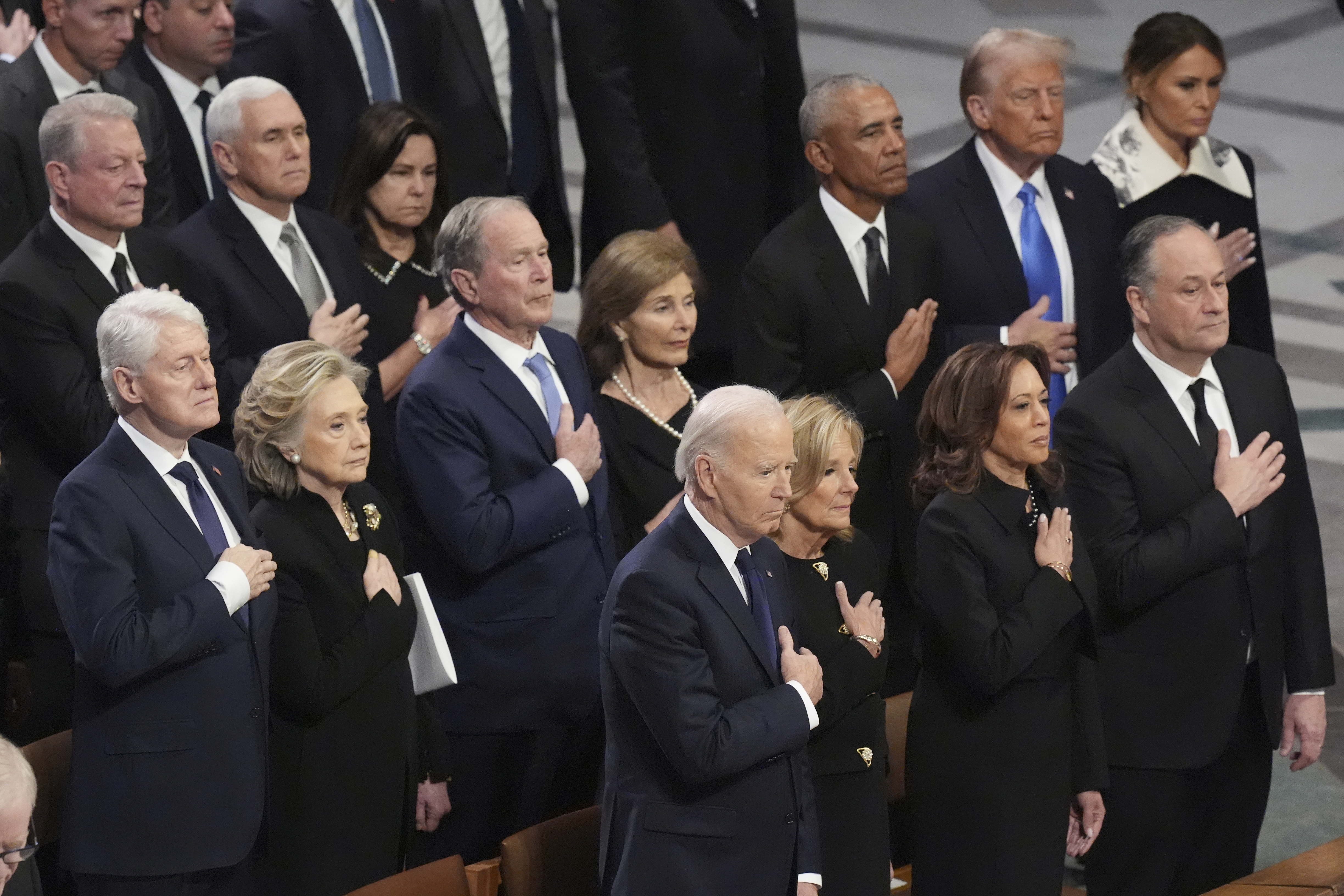 Front row, from left, President Joe Biden, first lady Jill Biden, Vice President Kamala Harris and second gentleman Doug Emhoff and second row from left, former President Bill Clinton, former Secretary of State Hillary Clinton, former President George W. Bush, Laura Bush, former President Barack Obama, President-elect Donald Trump and Melania Trump, stand during the state funeral for former President Jimmy Carter at Washington National Cathedral in Washington, Thursday, Jan. 9, 2025. (AP Photo/Jacquelyn Martin)