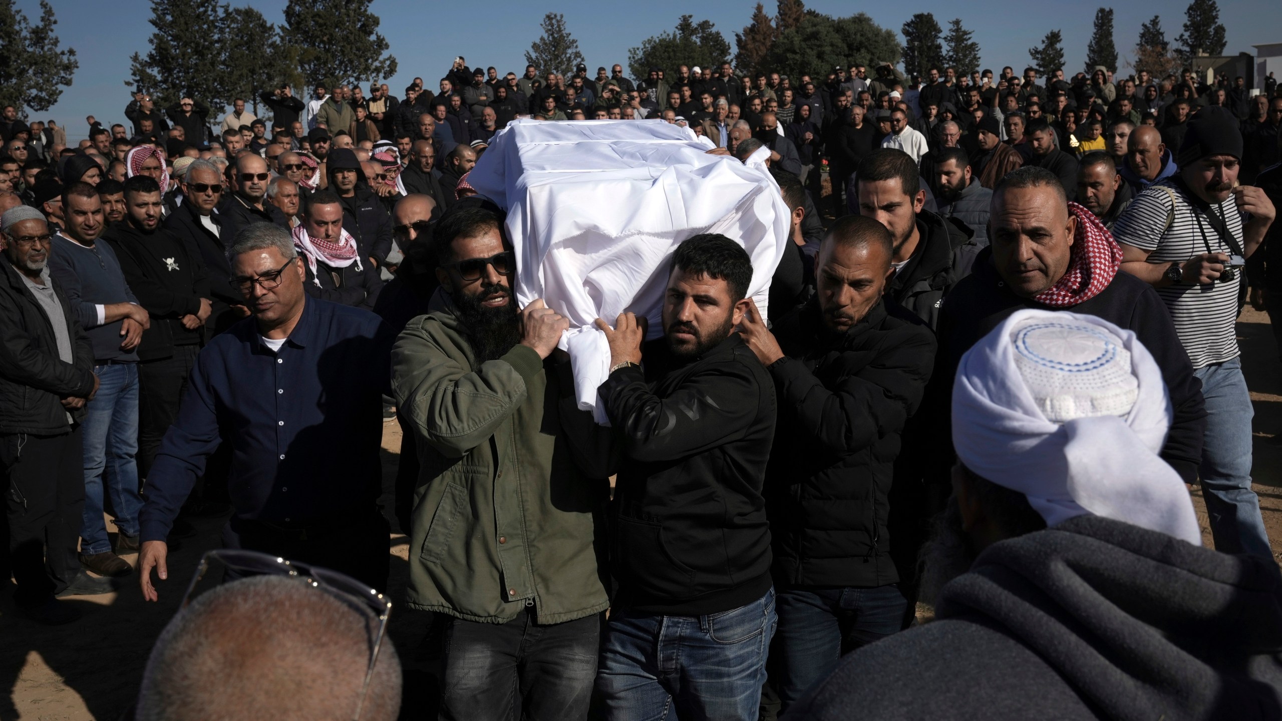 Members of the Bedouin community carry the body of Yosef Al Zaydani, who was in Hamas captivity in the Gaza Strip, a day after the Israeli army said his body was recovered in an underground tunnel in southern Gaza, during his funeral in Rahat, southern Israel, Thursday, Jan. 9, 2025. (AP Photo/Mahmoud Illean)