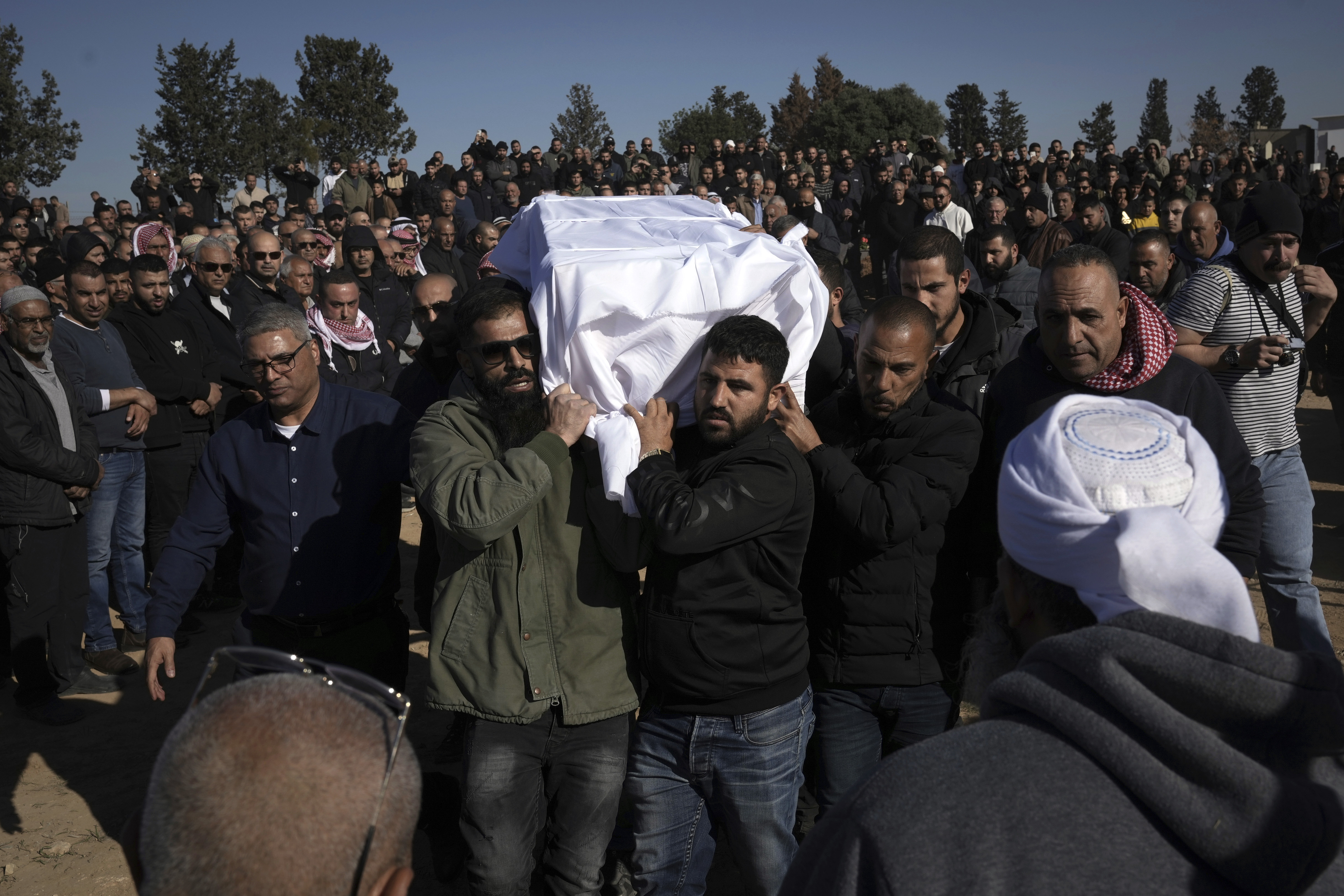 Members of the Bedouin community carry the body of Yosef Al Zaydani, who was in Hamas captivity in the Gaza Strip, a day after the Israeli army said his body was recovered in an underground tunnel in southern Gaza, during his funeral in Rahat, southern Israel, Thursday, Jan. 9, 2025. (AP Photo/Mahmoud Illean)