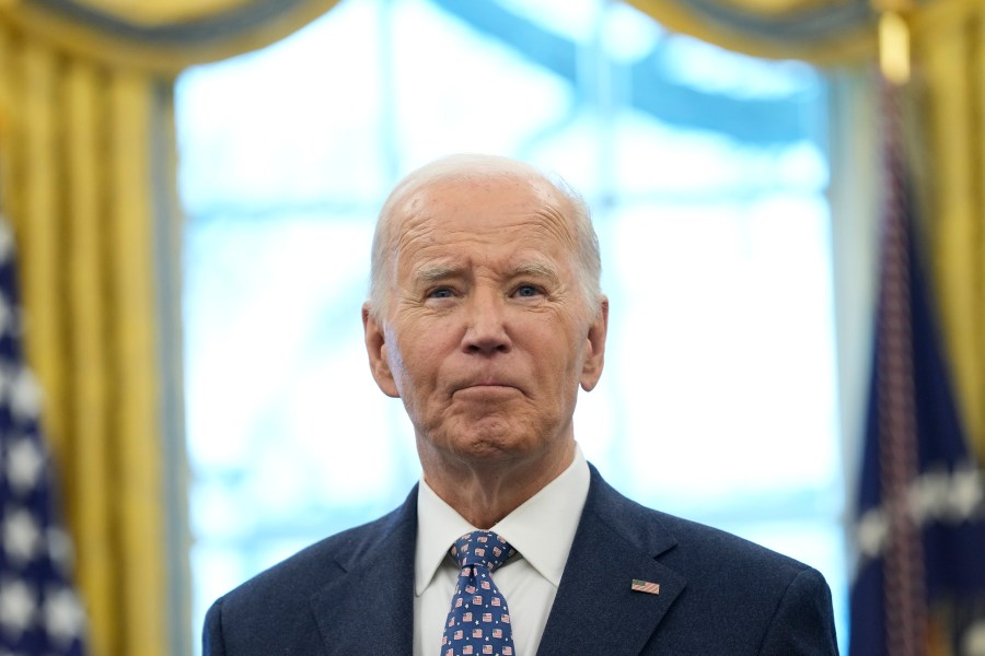 FILE - President Joe Biden pauses during a photo opportunity with Medal of Valor recipients in the Oval Office of the White House in Washington, Jan. 3, 2025. (AP Photo/Susan Walsh, File)