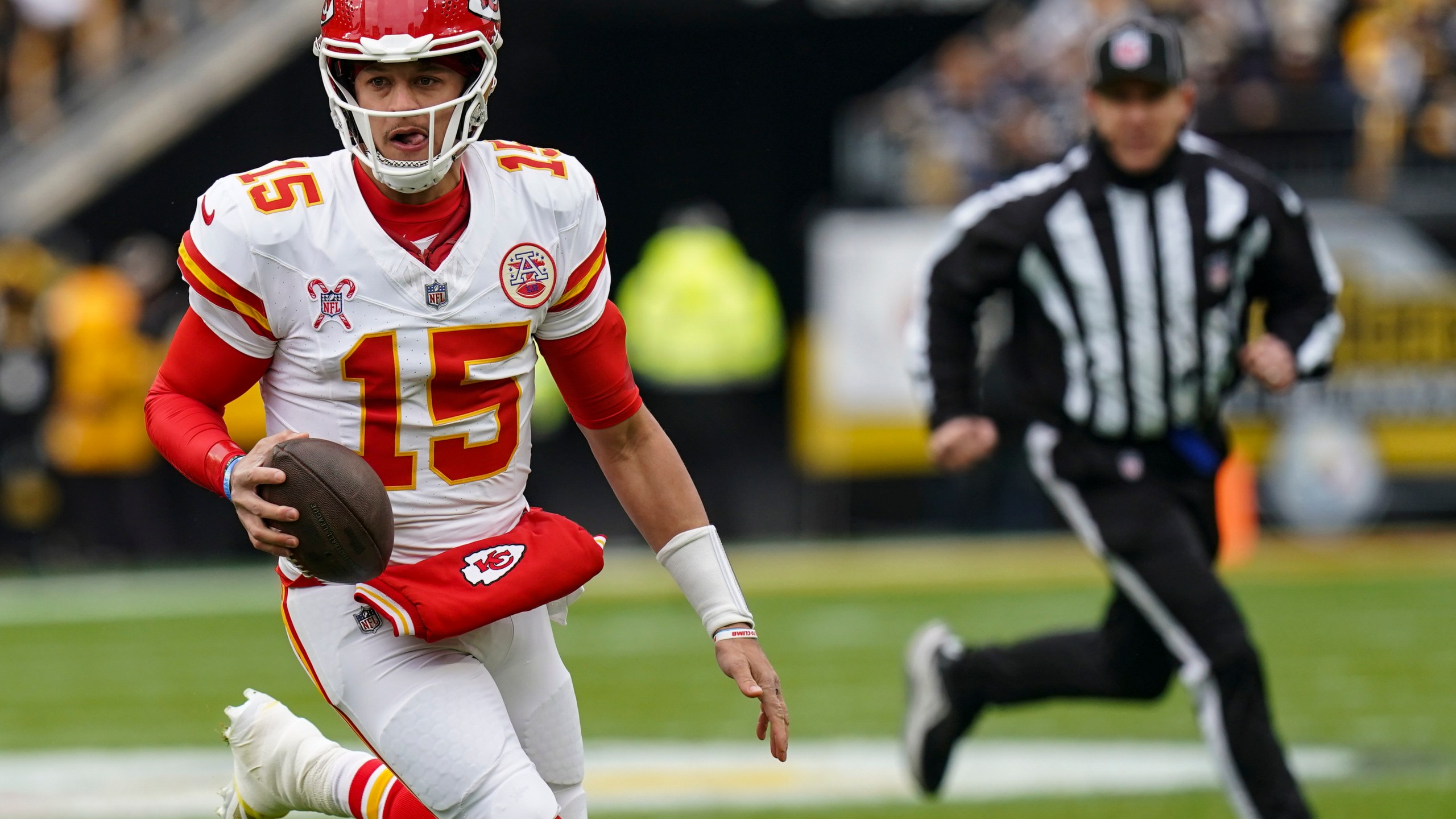 Kansas City Chiefs quarterback Patrick Mahomes (15) runs out of the backfield against the Pittsburgh Steelers during the first half of an NFL football game, Wednesday, Dec. 25, 2024, in Pittsburgh. (AP Photo/Matt Freed)